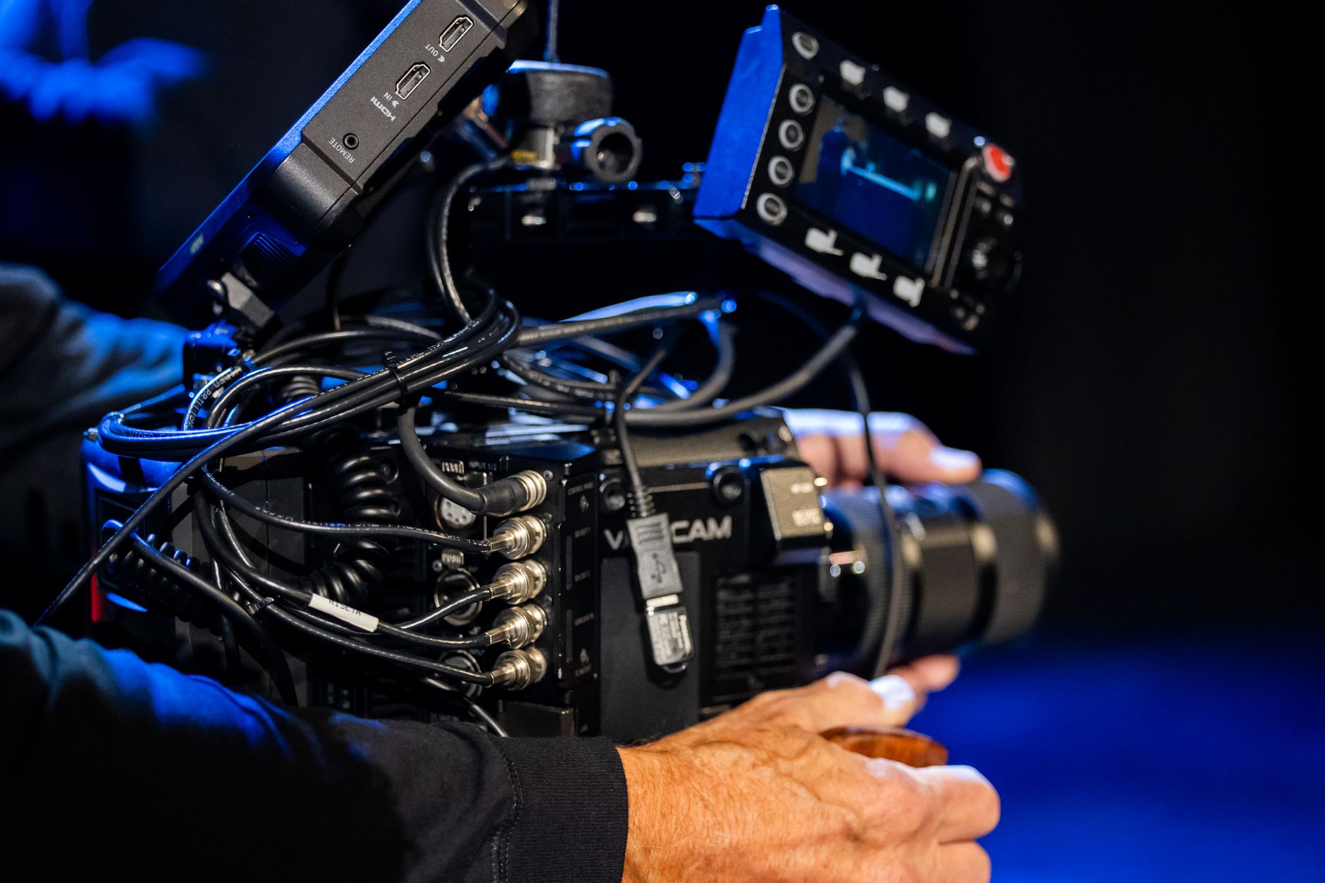 Production cables and equipment cases arranged across a studio floor that must be protected during cleaning.