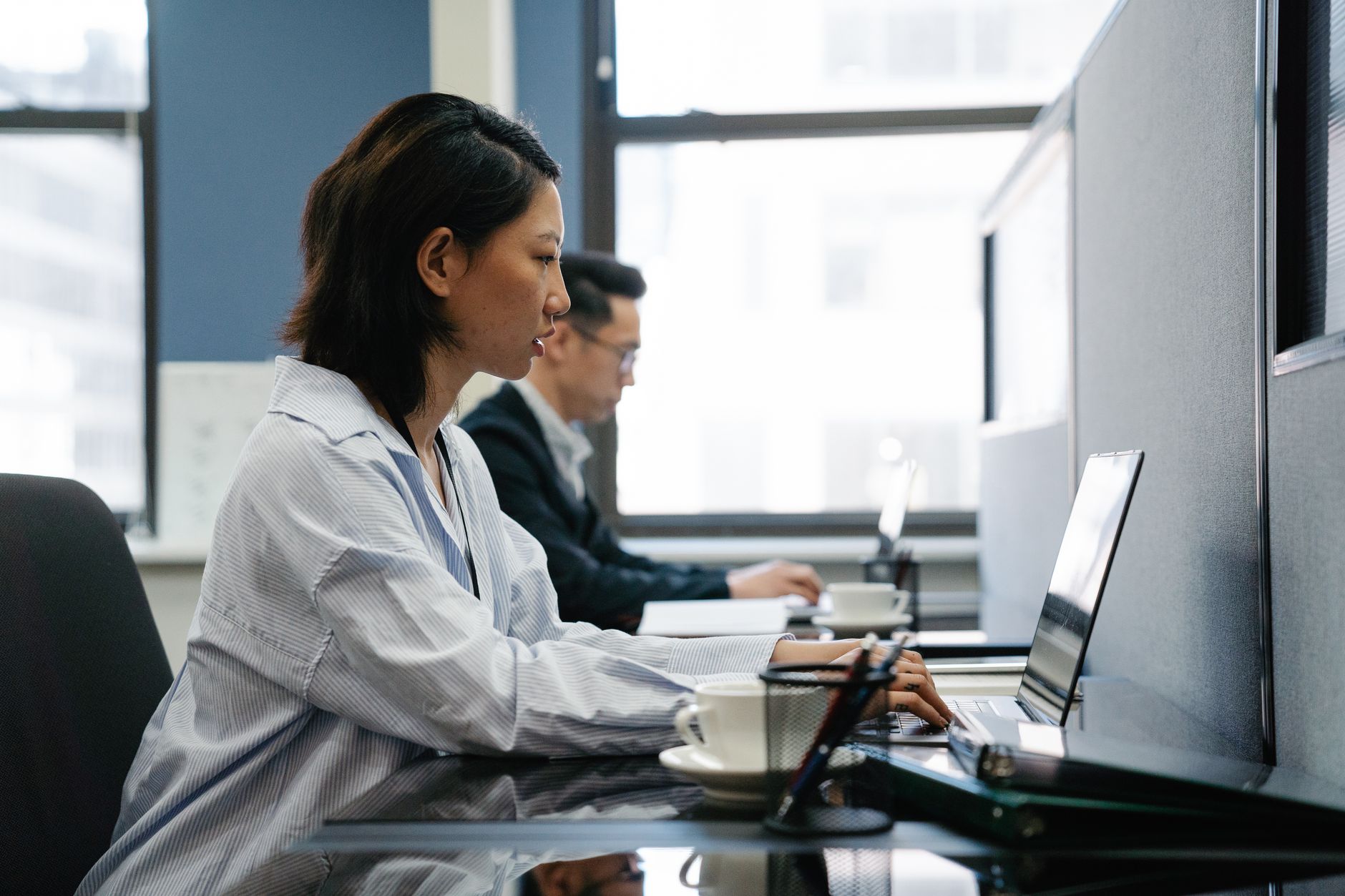 An open-plan office where employees are concentrating, a setting that benefits from quiet cleaning robots during the day.