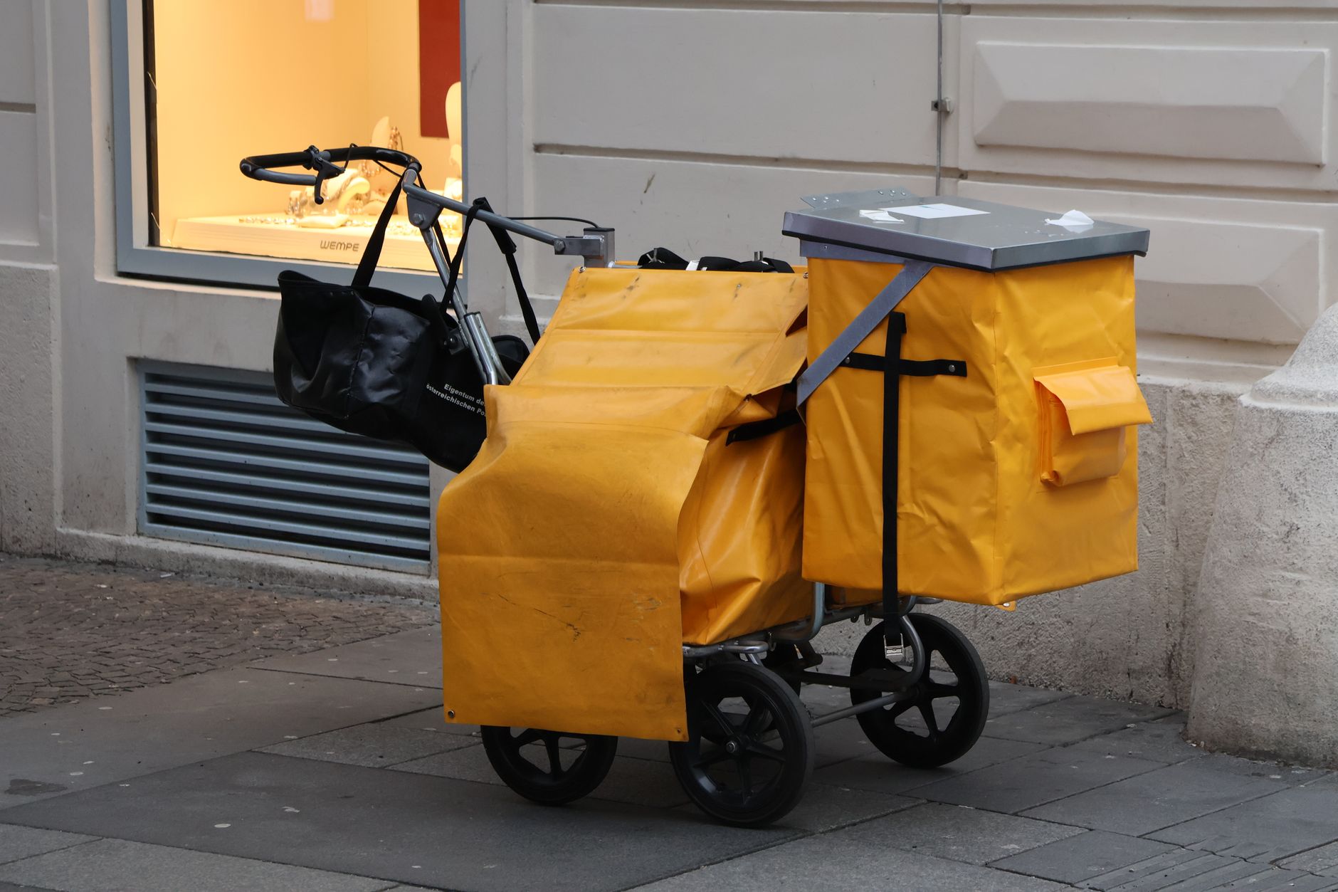 A supply cart in a commercial hallway, a manual baseline to compare against robotic delivery pilots.