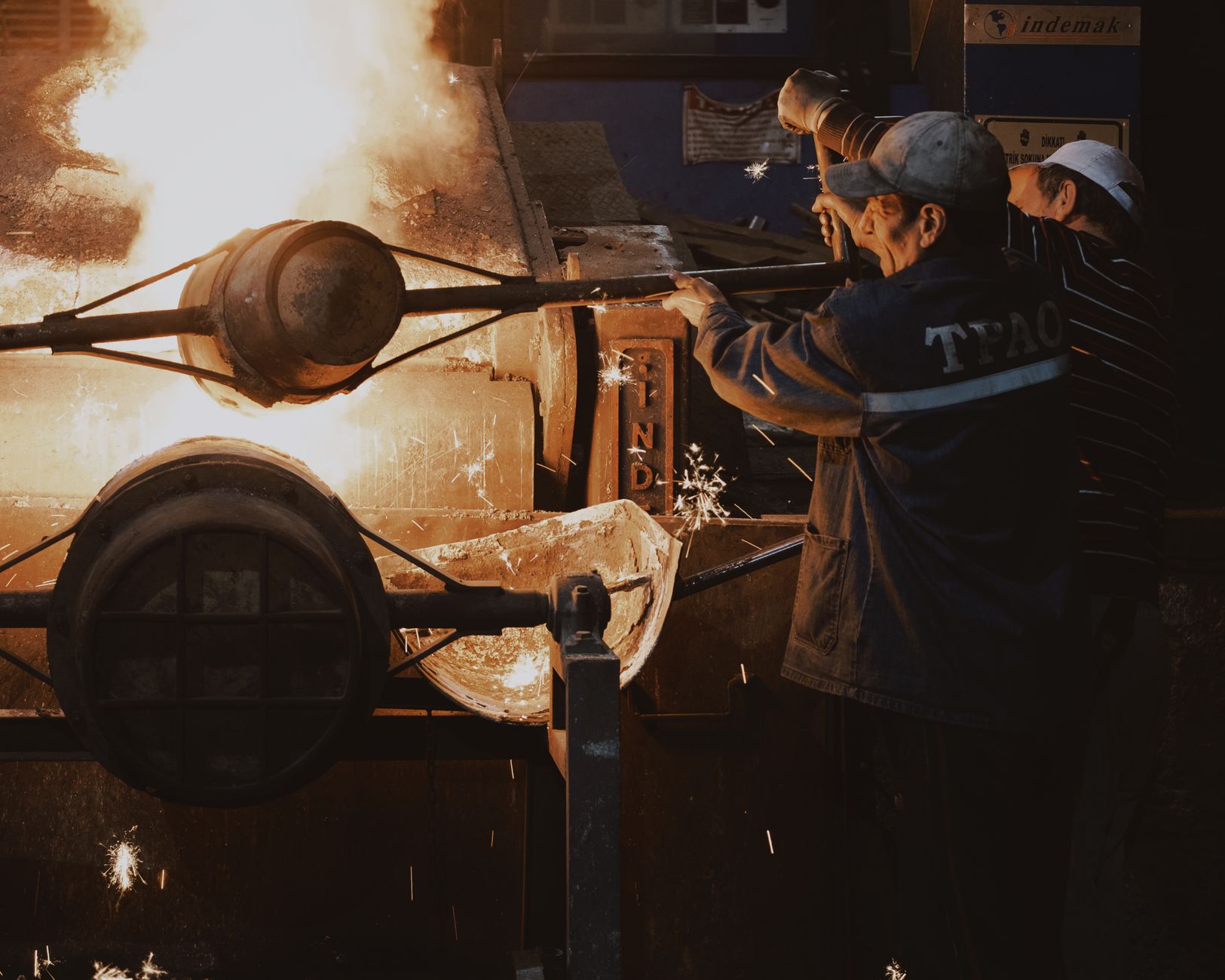 A worker in a hot industrial facility appears fatigued, illustrating the workplace dangers of heat stress that OSHA's 2026 program targets.