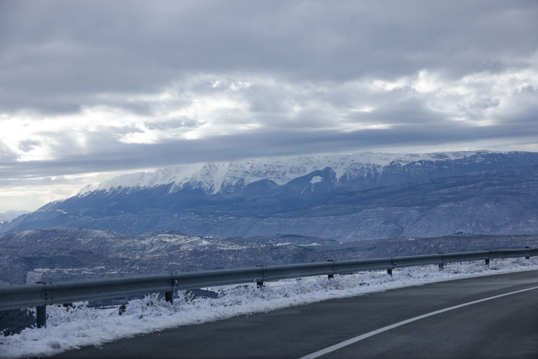 A snowy mountain road scene illustrating slush and salt carried into lodge entries after storms.