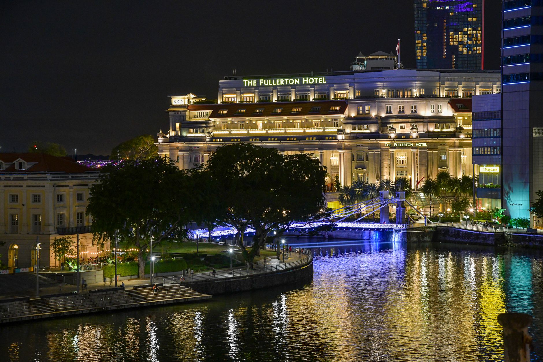 Soft downward lighting illuminates a resort walkway at night without glaring into guest rooms.