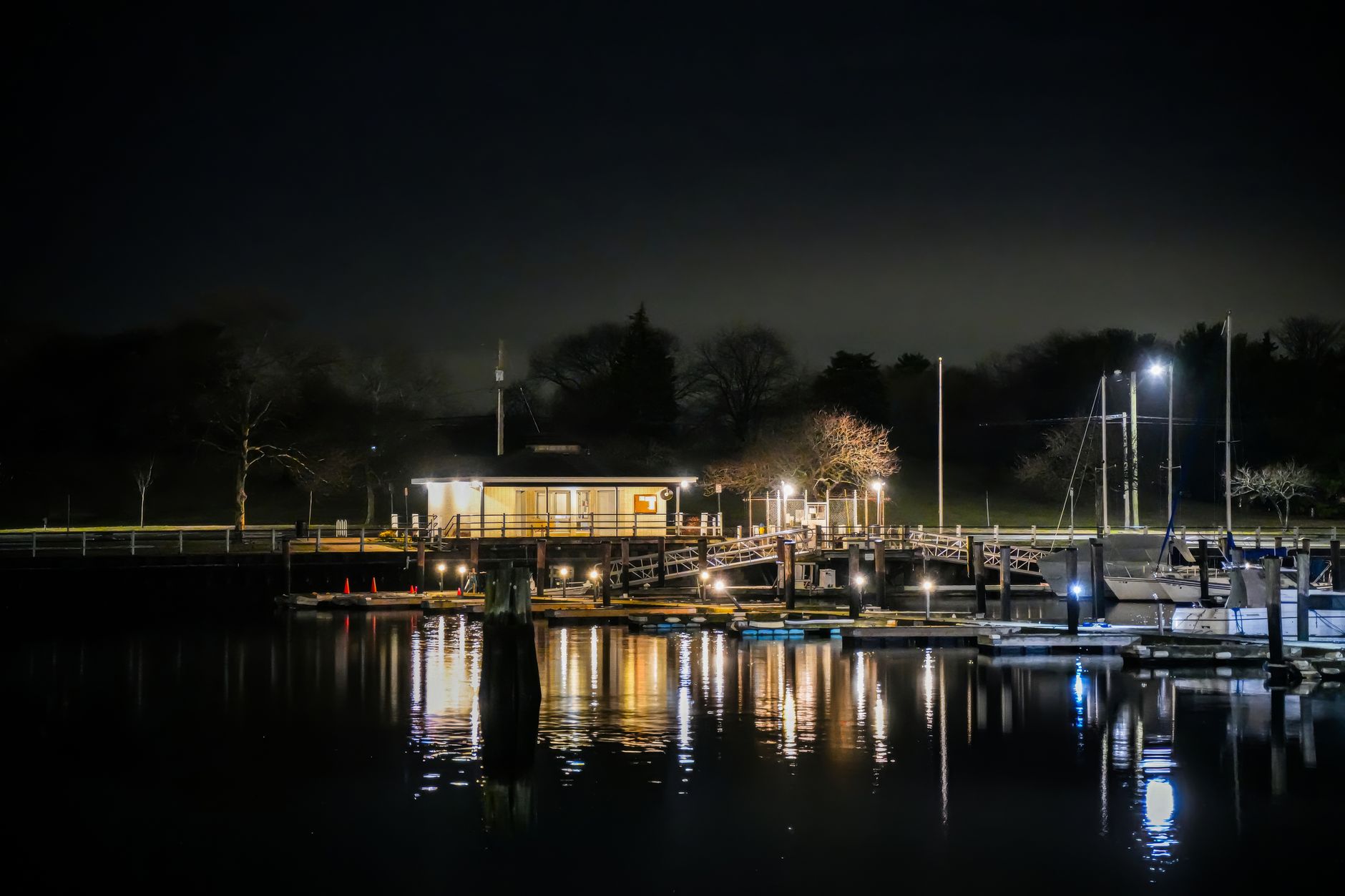 Finger piers and dock lights at a marina after dark