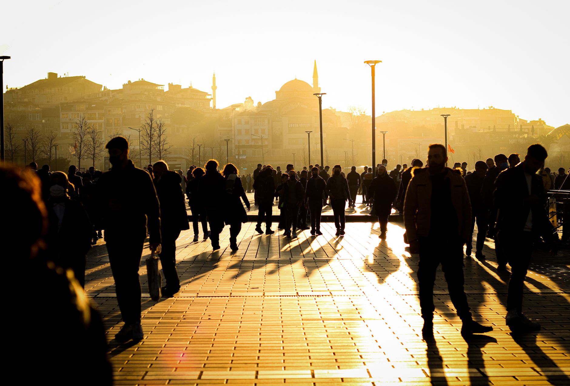 Pedestrians crossing a parking lot after an event, illustrating the post credits surge patrol routes must slow down for.