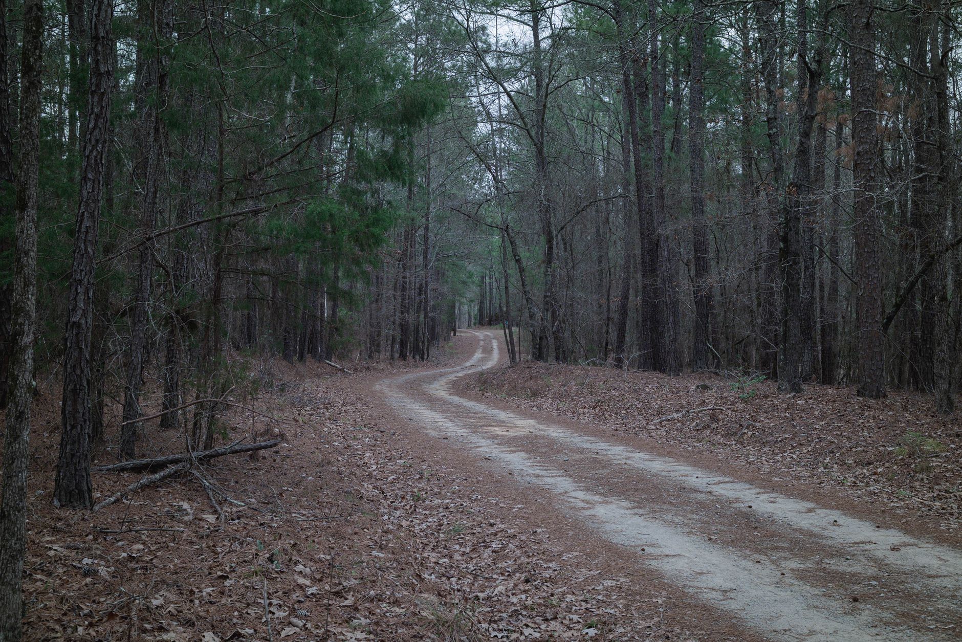 Gravel access road leading to a fenced compressor yard mapped for patrol checkpoints.