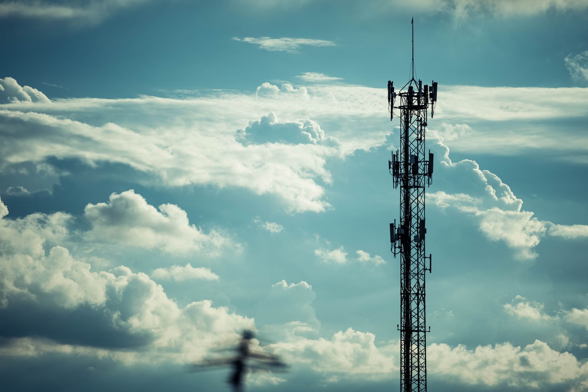 A remote telecommunications tower compound stands in an isolated rural landscape.