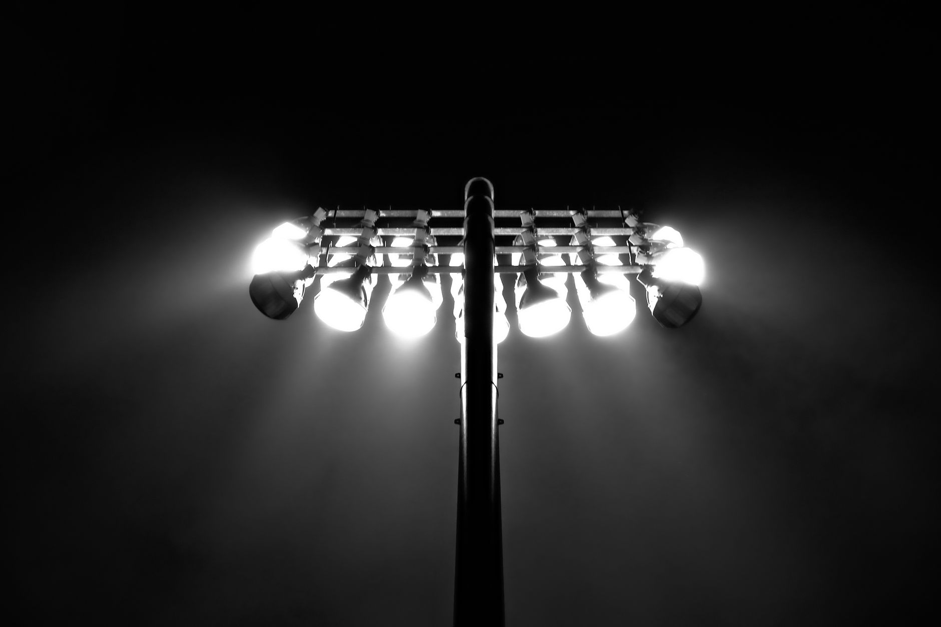 Outdoor floodlights illuminating a vehicle storage area at night.