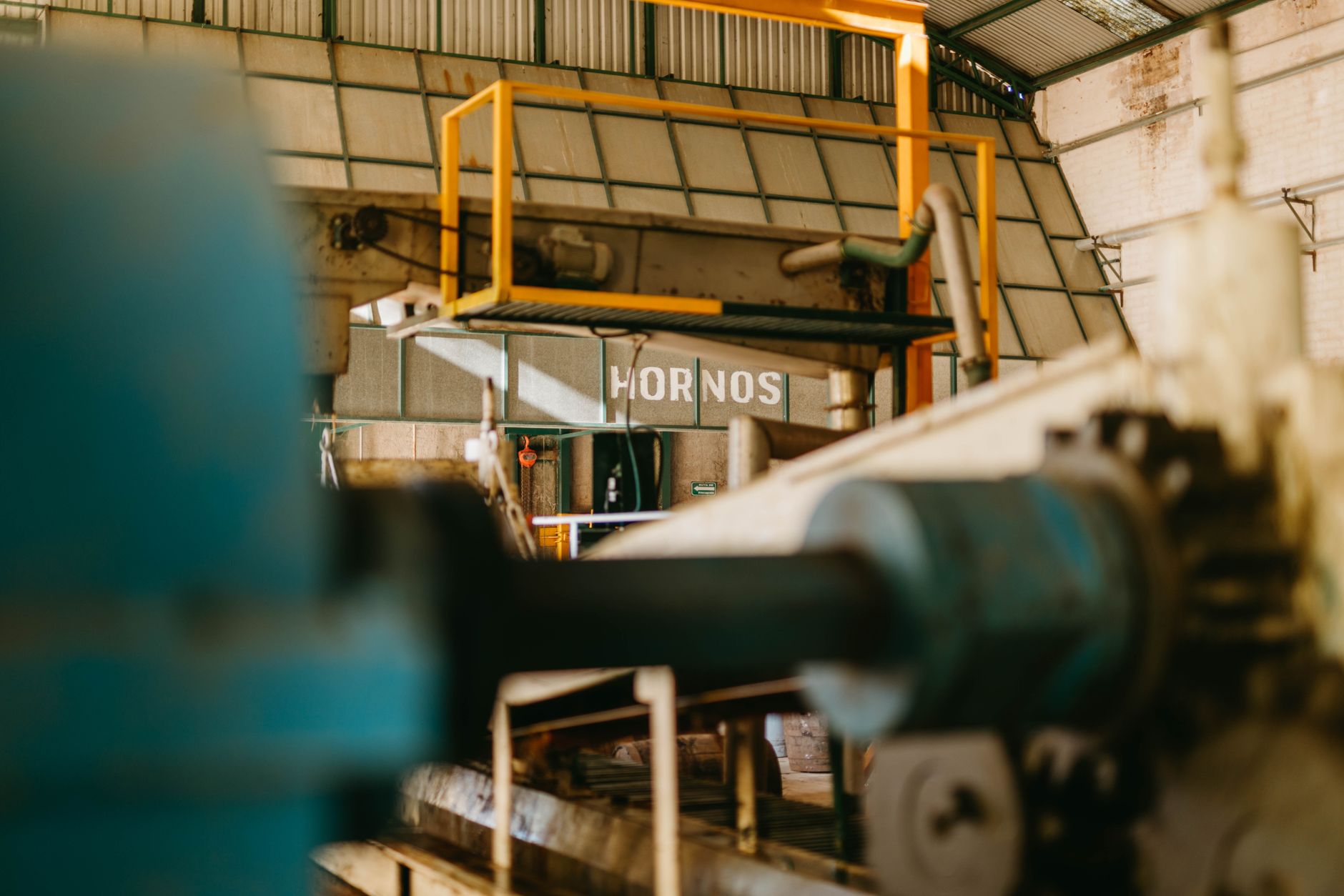 A busy machine shop floor illustrates the operating environment where one cobot may be shared across several machines.