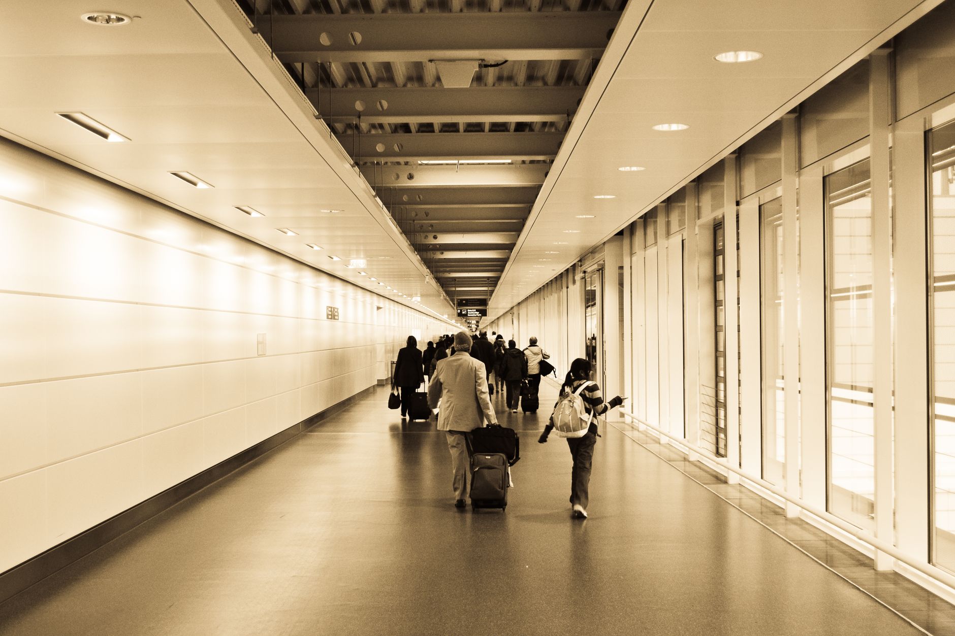 A long airport concourse where overnight floor cleaning runs after the last departure.