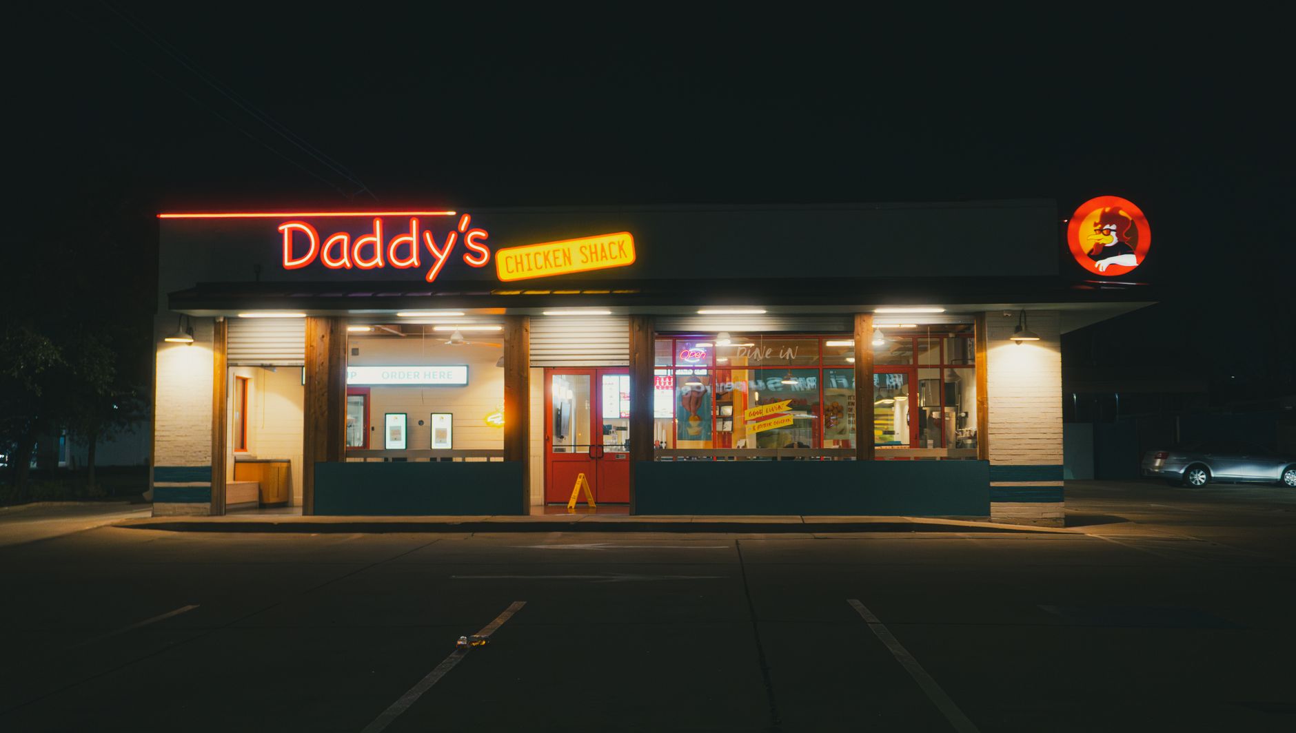 A highway-side retail entrance where traveler foot traffic tracks grit onto the threshold.