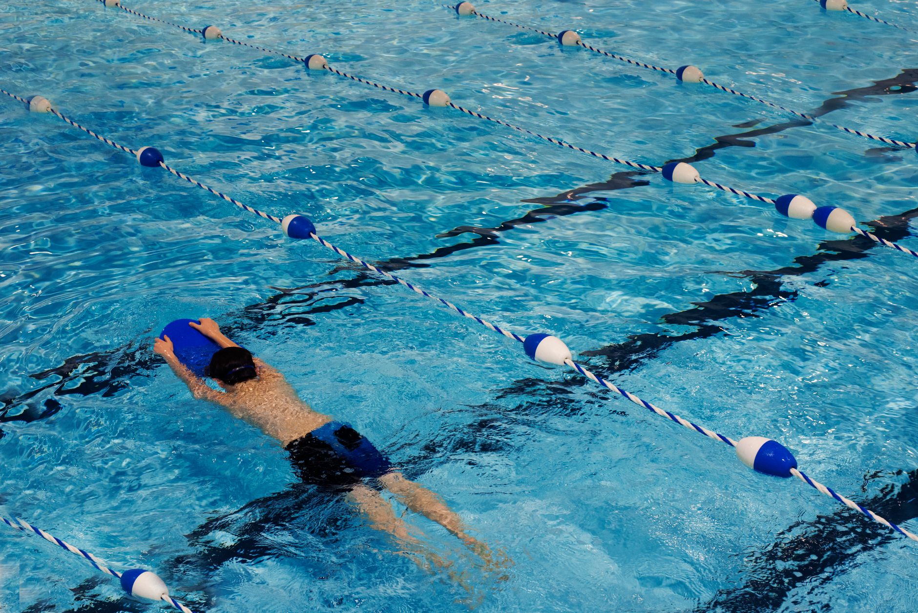 Lane ropes and barriers at a public pool that mark zones during maintenance.