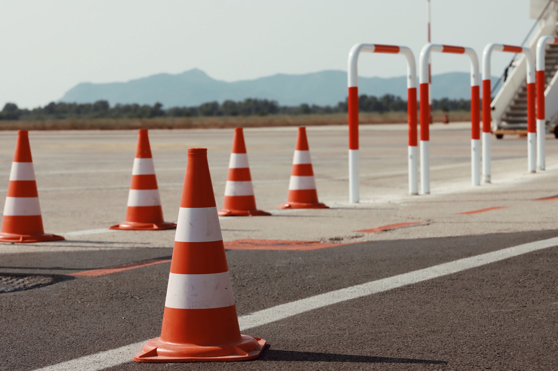Cones marking a cordoned aisle while floor cleaning runs during quiet hours.
