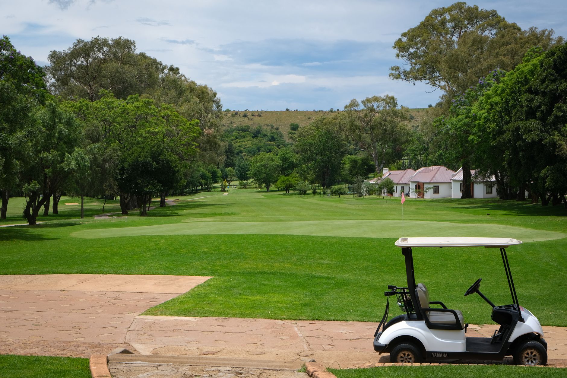A cart path at dawn on a quiet golf property