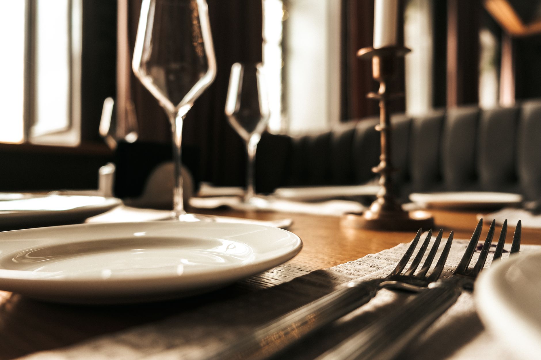 Restaurant staff finishing sidework after close in an empty dining room