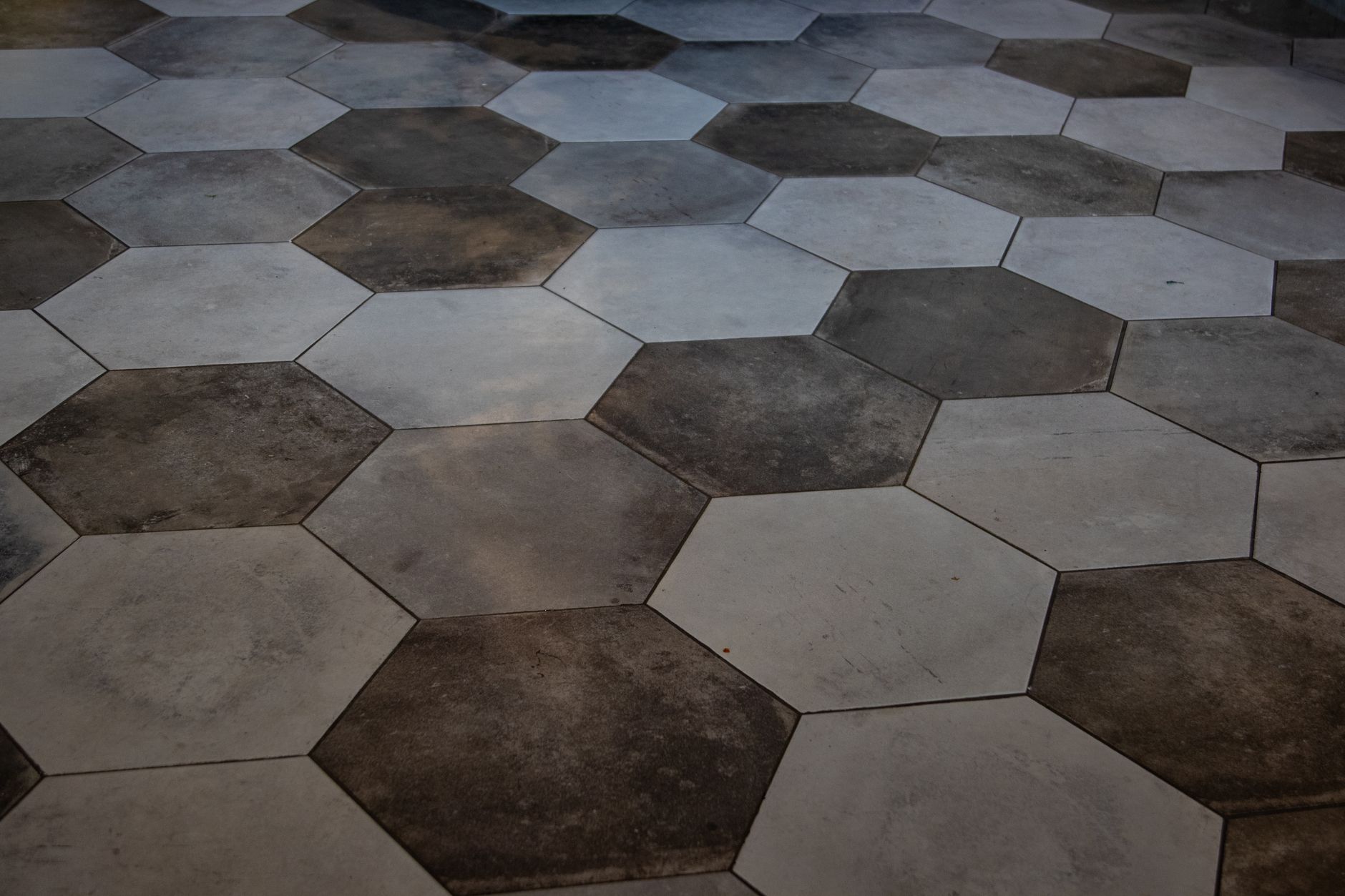 Shared mudroom tile where quiet-hour scrubbing keeps grit off guest corridors.