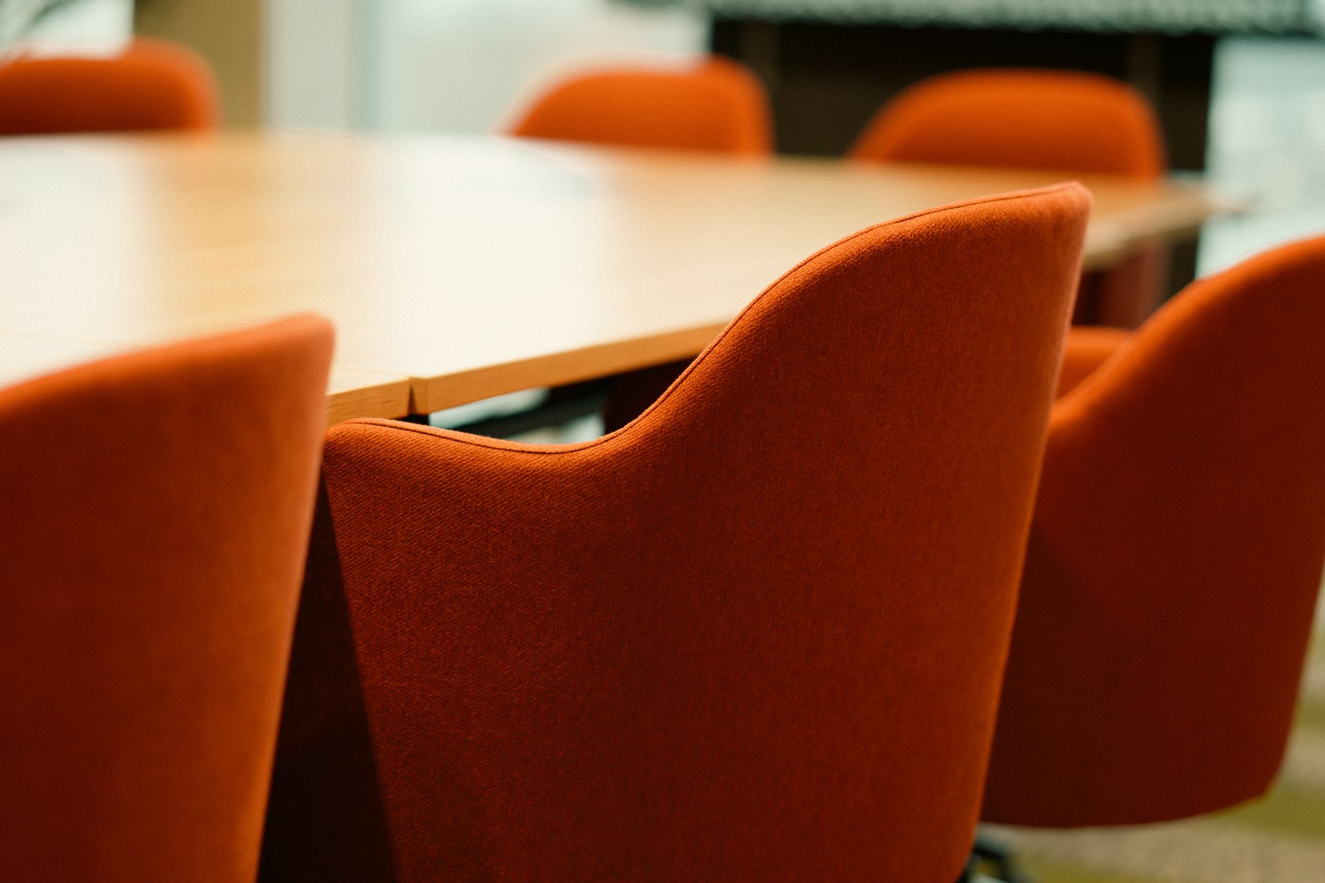 Operations and IT leads at a table, the kind of signoff meeting that closes site acceptance testing.