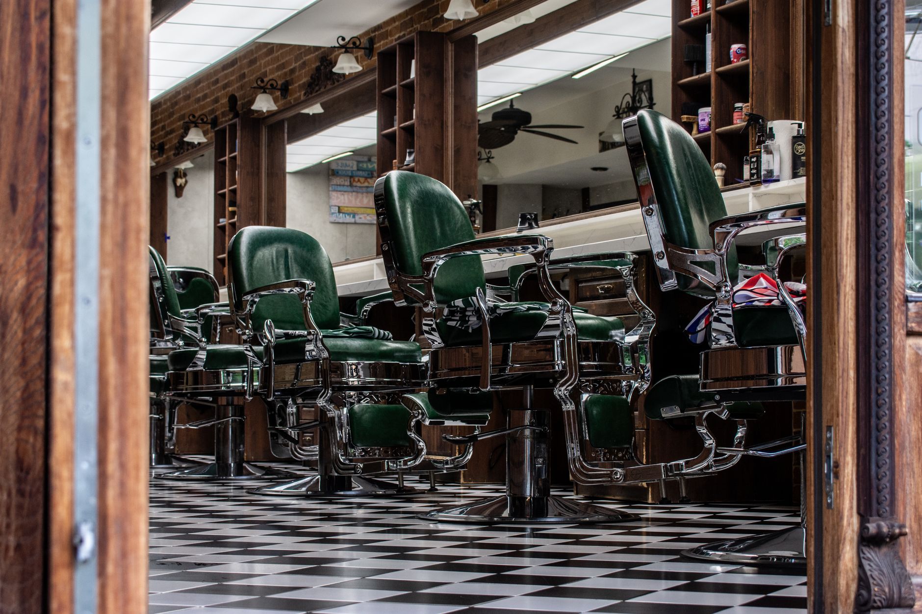 Row of salon styling chairs pushed back to clear a floor lane.