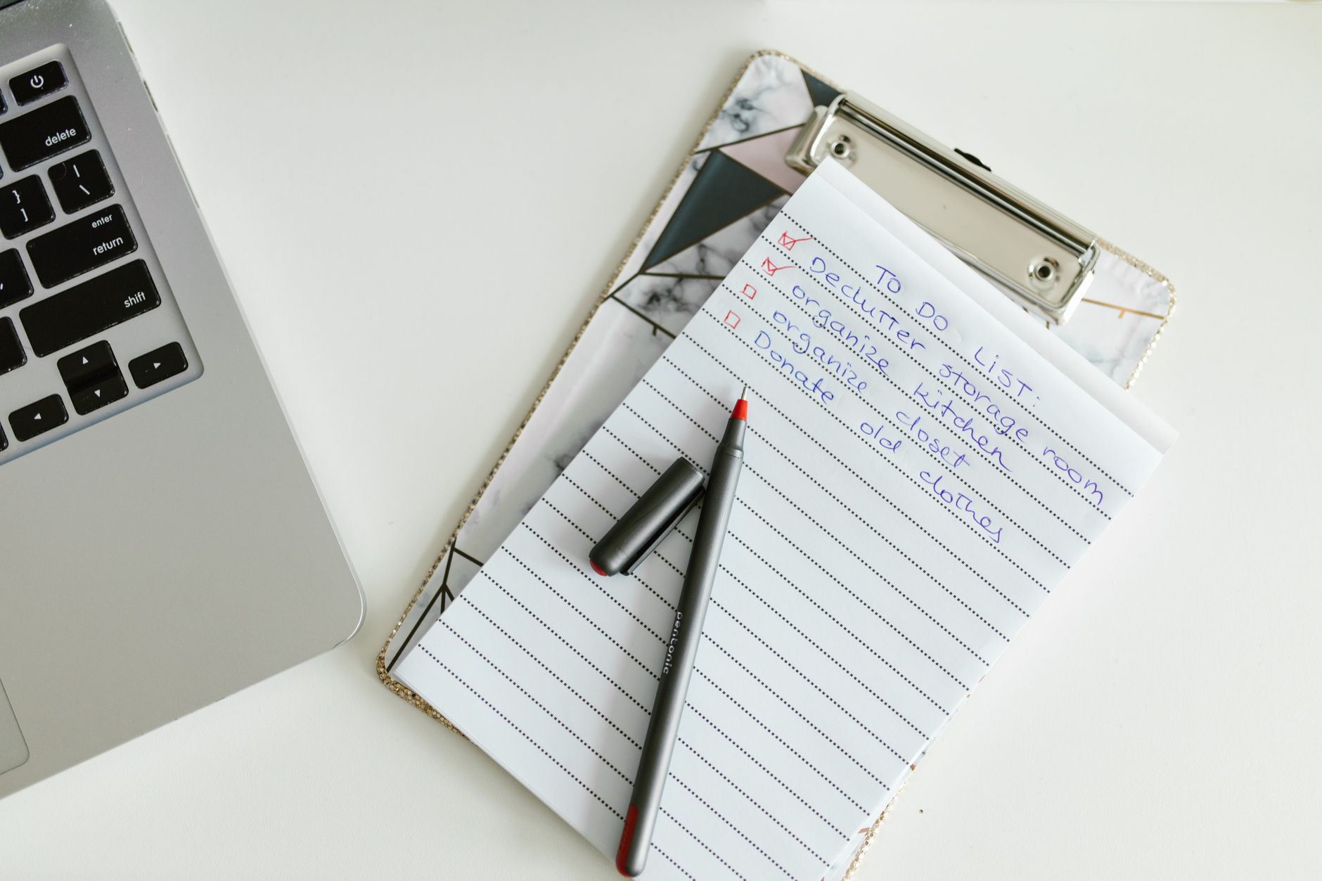 A checklist on a desk represents the one-page pilot scorecard operations and finance should update weekly.