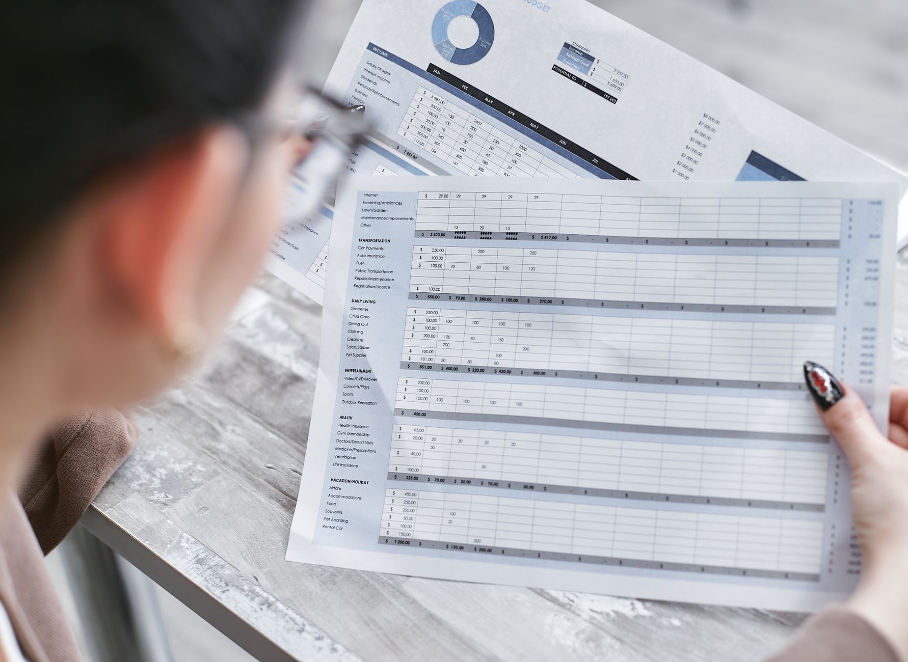 Operations and finance staff reviewing a spreadsheet, the kind of side-by-side work needed to compare robot subscription quotes.