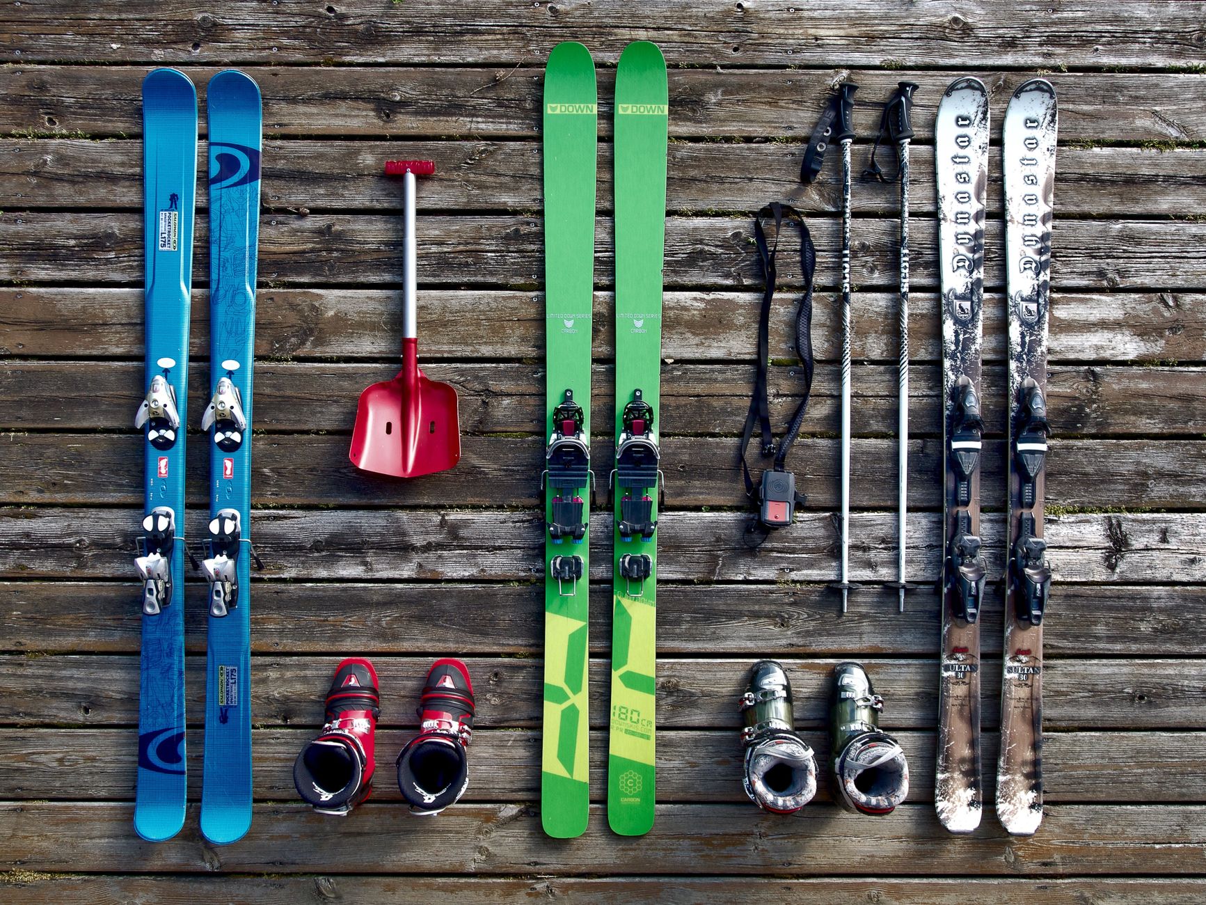Wet ski boots leave snow, grit, and meltwater on an indoor floor.