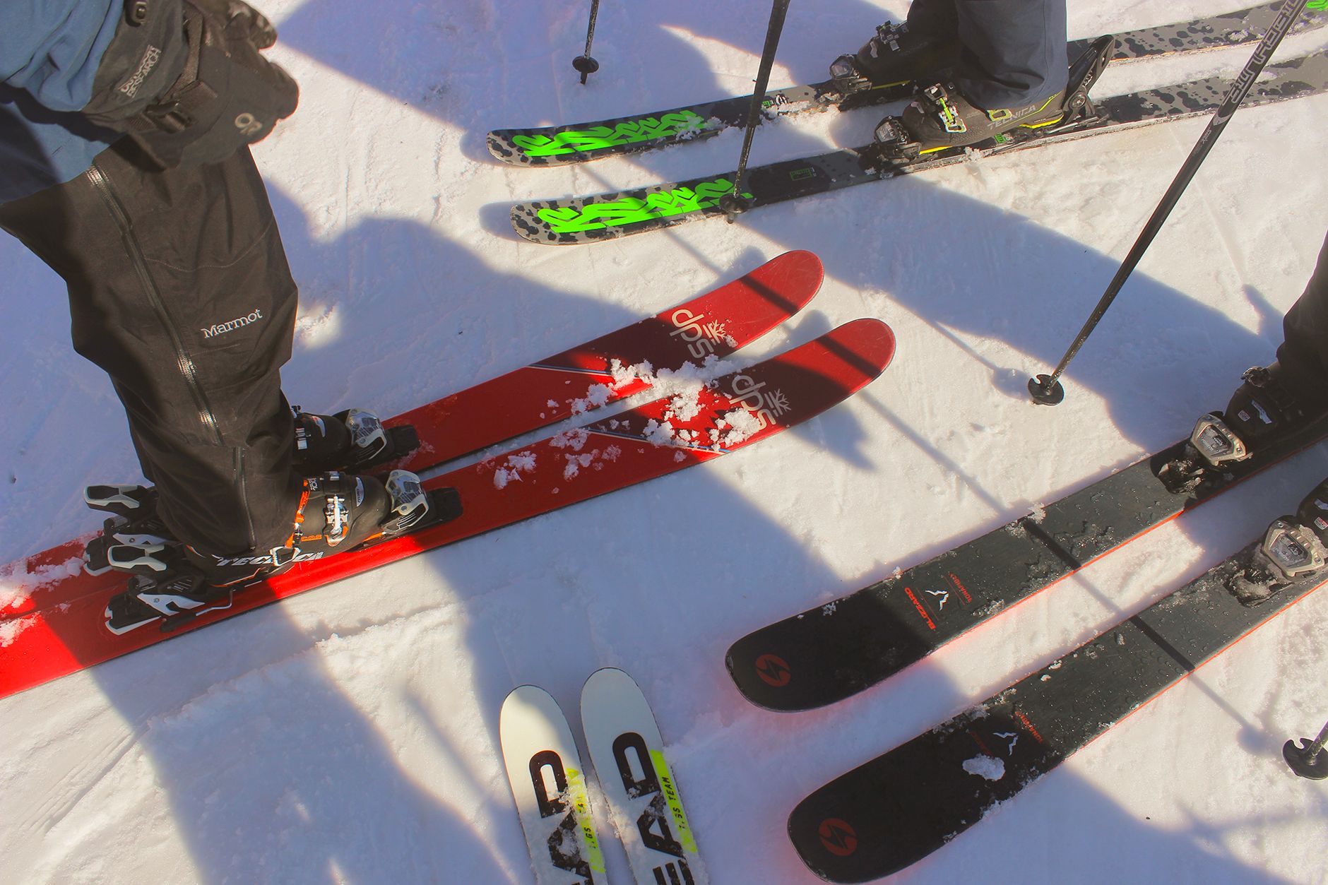 Customers try on ski boots around fitting benches in a crowded rental area.