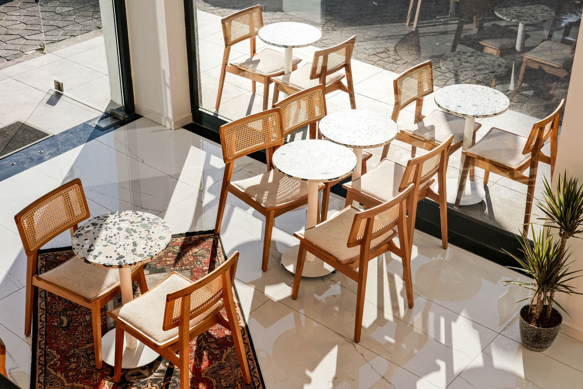 A polished terrazzo floor with material transitions typical of a premium airport lounge.