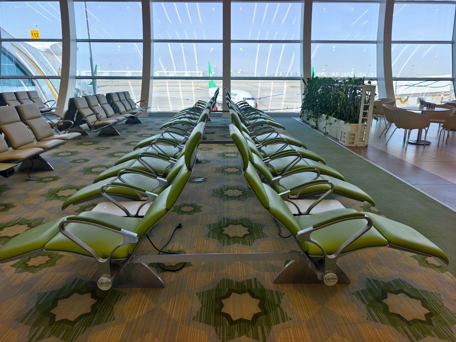 A premium airport lounge with varied seating areas and open floor paths between departure rushes.
