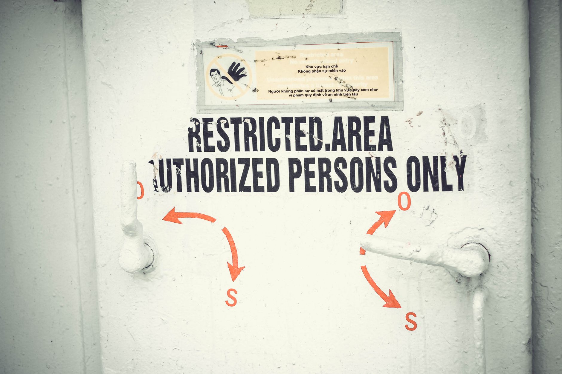 A clearly marked restricted doorway separating a public lobby from an employee-only area.
