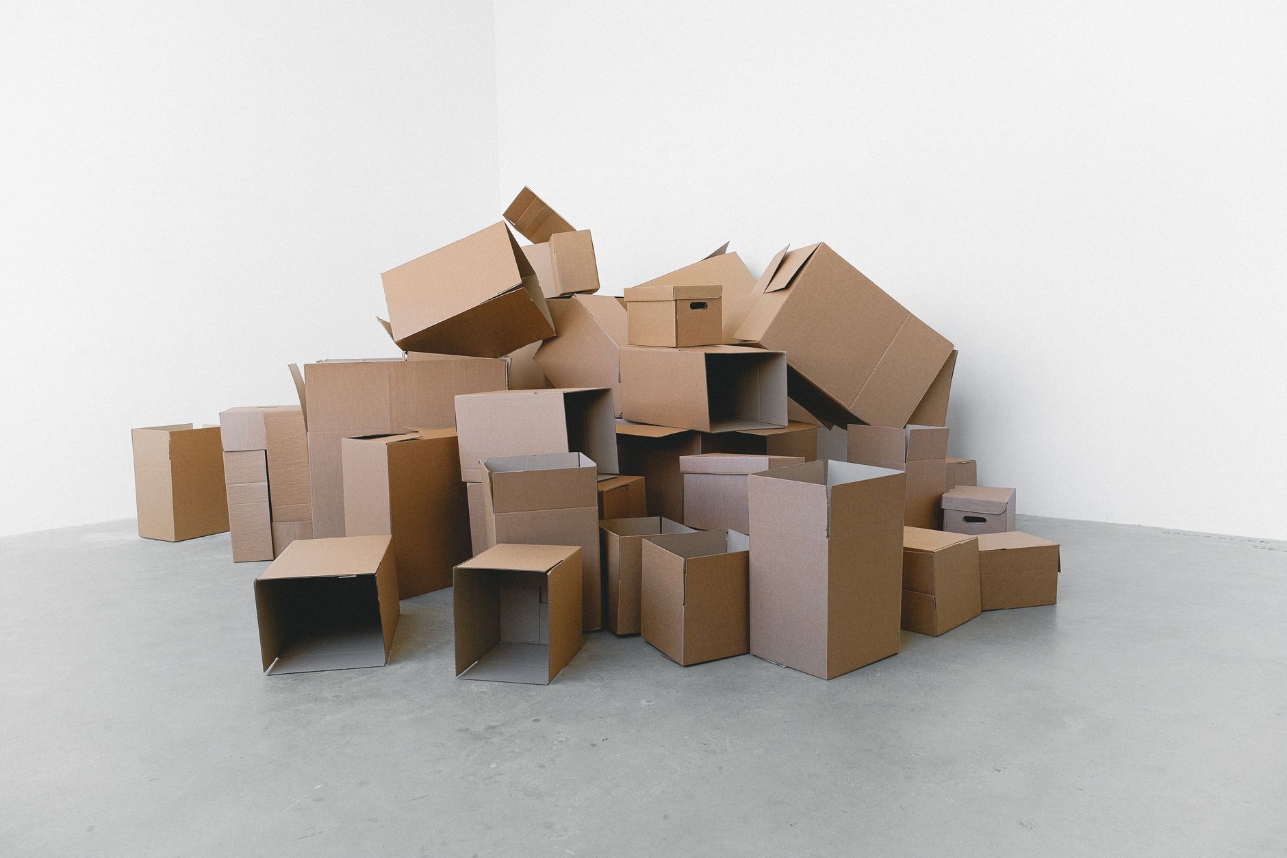 Cardboard and wrap staged along a floor edge, a common trigger for dynamic robot exclusion zones.