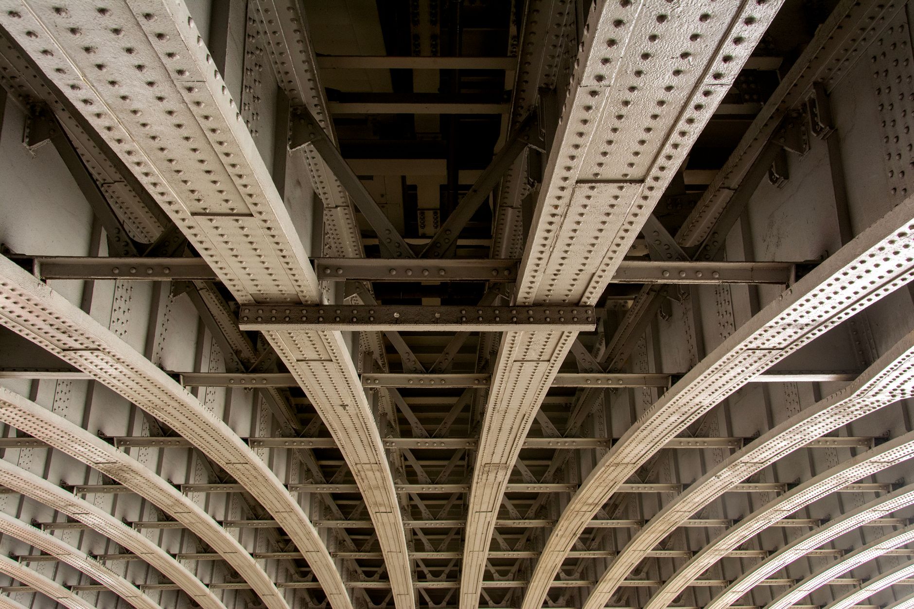 The underside of a highway bridge showing structural supports and difficult-to-reach inspection areas.