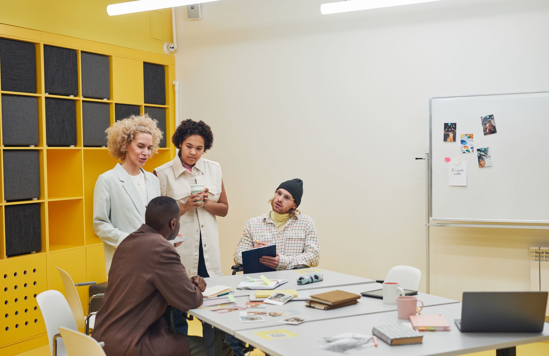 Employees meet around a table in a business office, representing the employer firms surveyed by the Census Bureau.