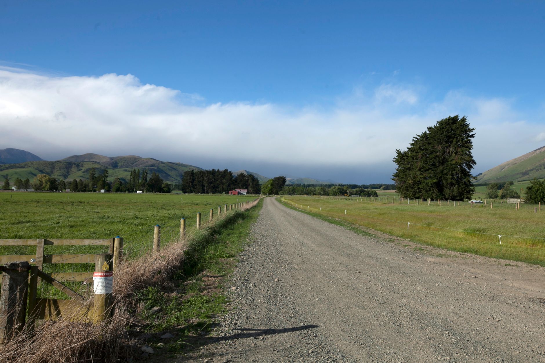 A rough gravel service road with uneven outdoor conditions similar to the terrain that can complicate yard patrol routes.