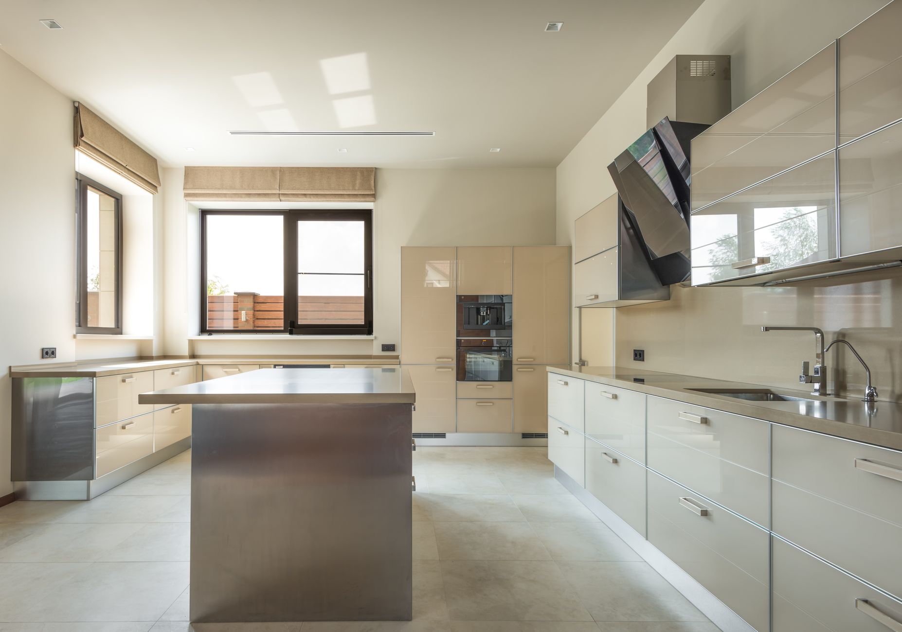 Bright stainless surfaces in a food production area where lighting and glare affect interior oven imaging.