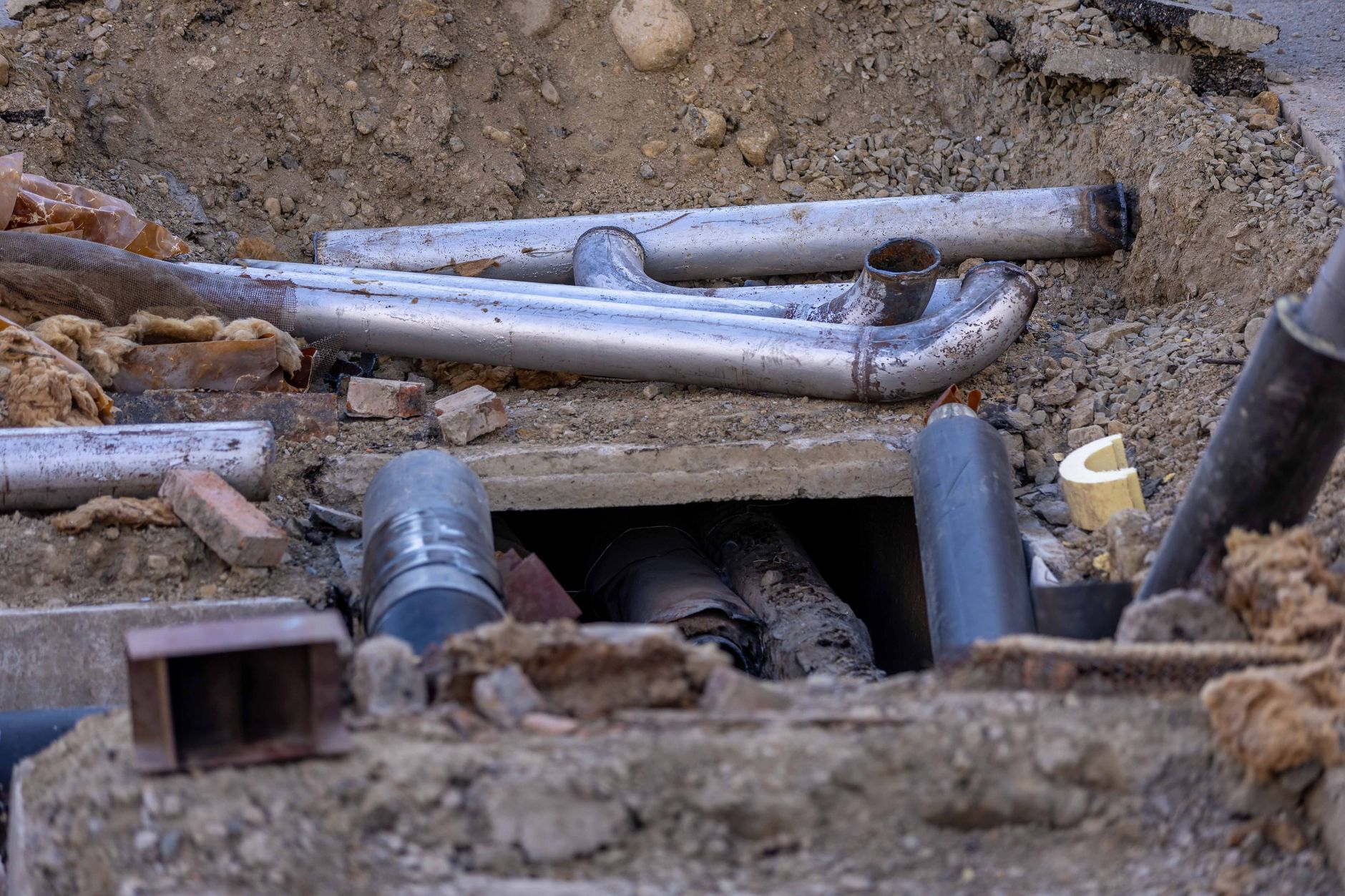 Open concrete utility sump at a fuel site where vapor control and classified equipment rules apply.