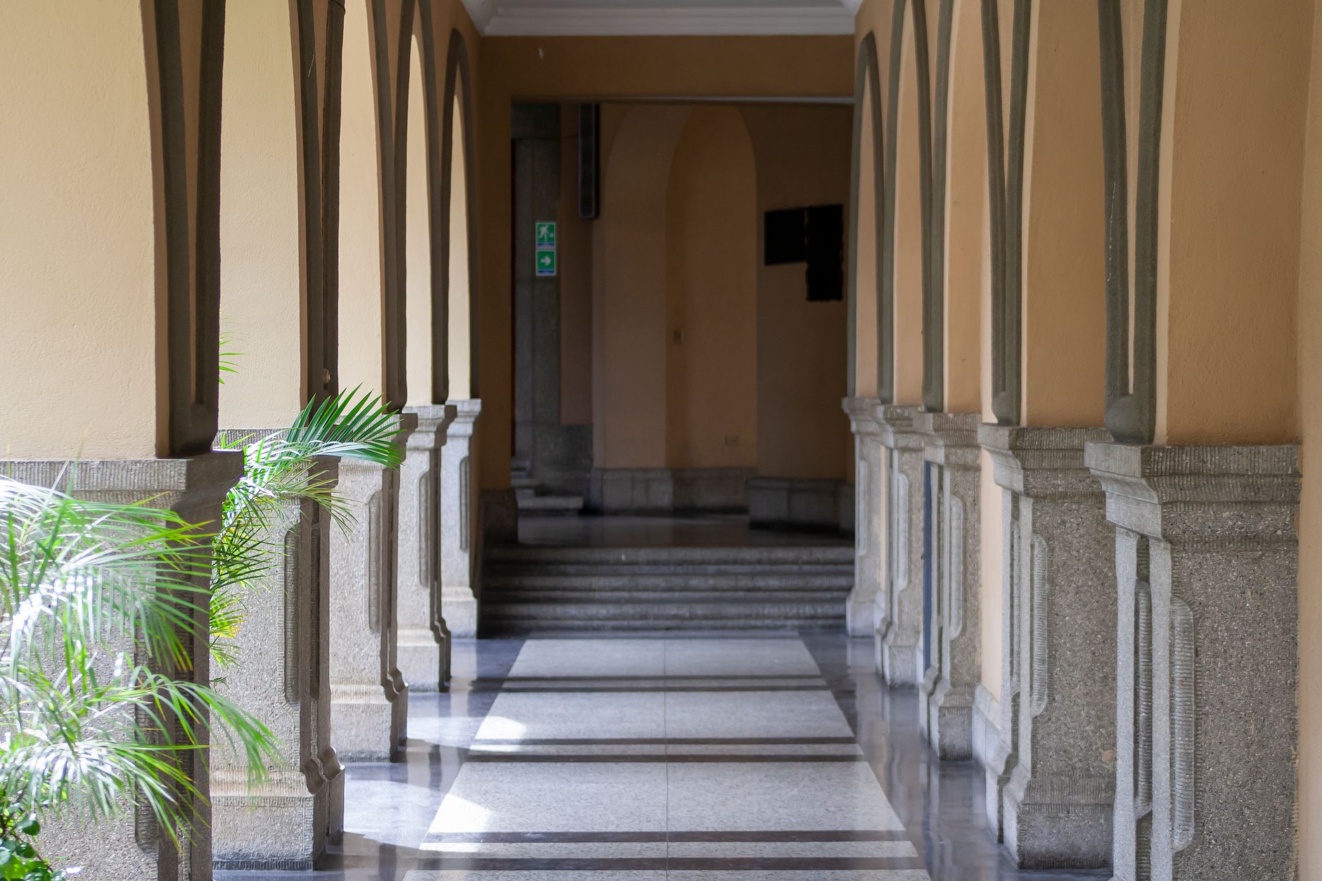 A long rec-center corridor with multiple doorways and durable flooring, showing the kind of mixed-use route that only works well when nightly closeout is disciplined.