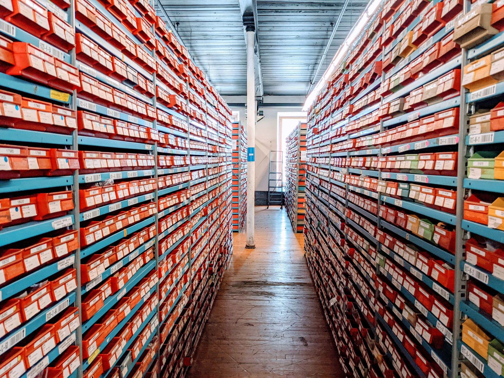 Long, glossy retail aisle with clear walking lanes, illustrating the kind of repeatable hard-floor route that suits overnight cleaning.
