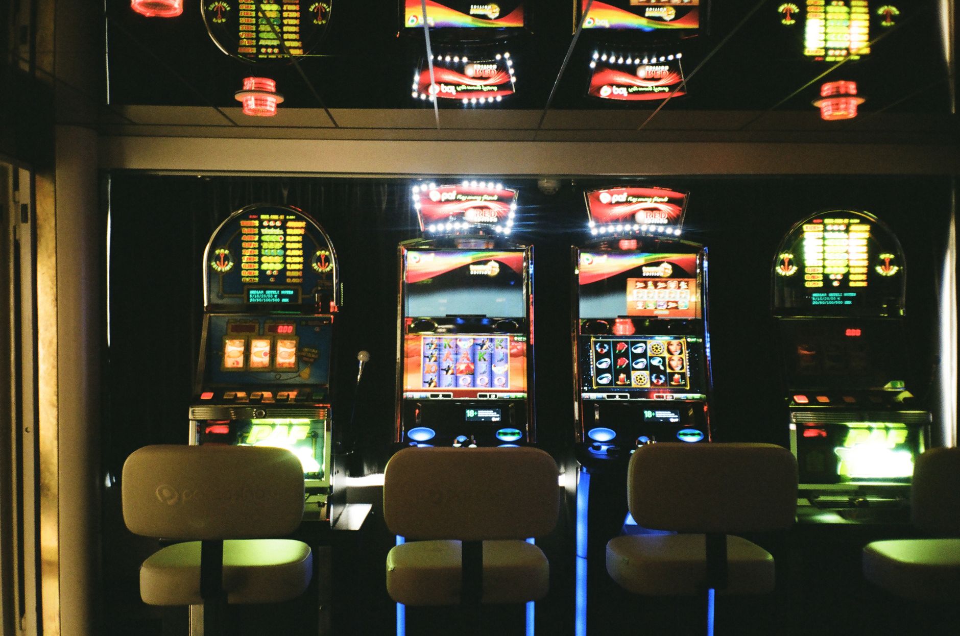 Guest-facing lounge and arcade seating area where food traffic and track grime mix in an indoor karting venue.