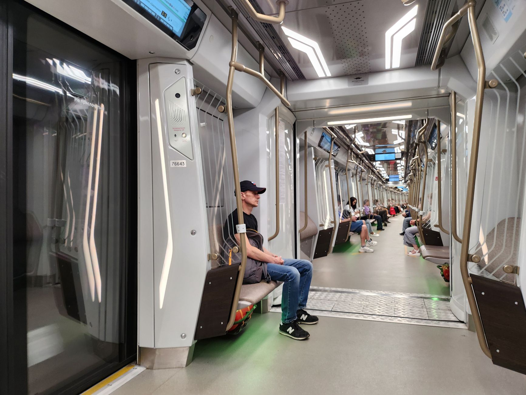 Vestibule area inside a passenger railcar showing doors, thresholds, and tight turning space.