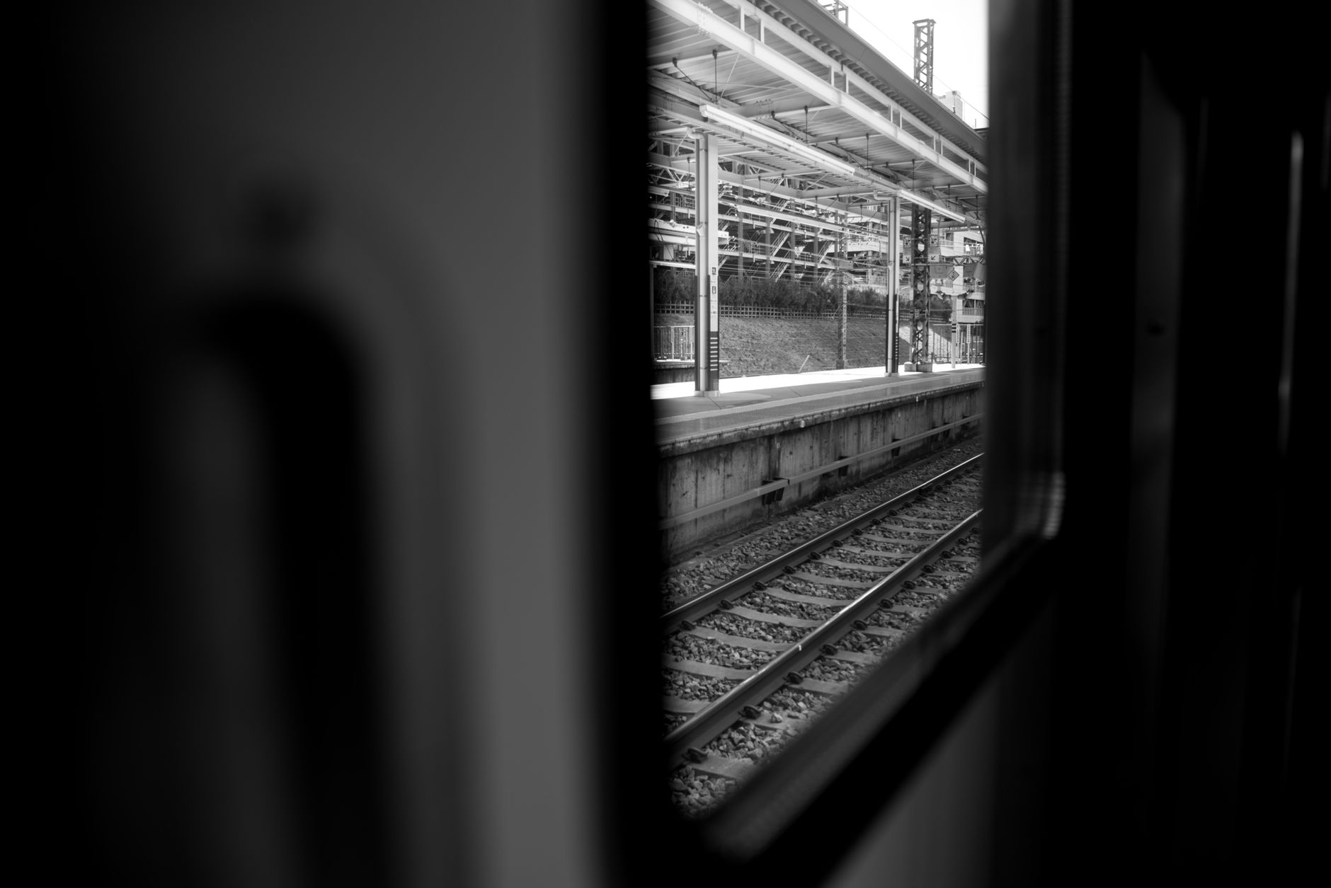 Open passenger-train doorway beside a platform edge that would need strict drop-edge control during cleaning.