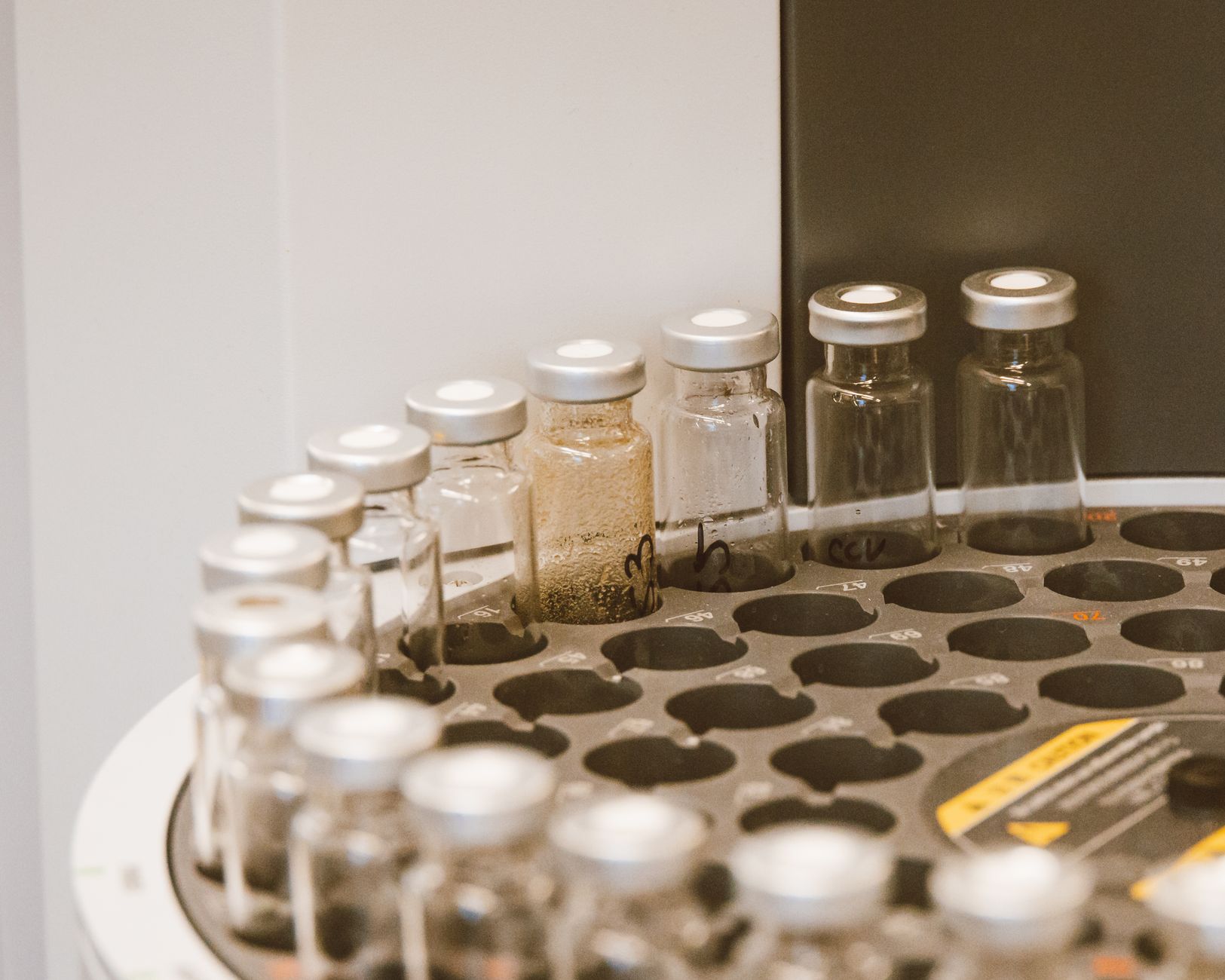 Close-up of neatly organized racks of test tubes containing samples, illustrating the sensitive materials that require secure transport within a lab.