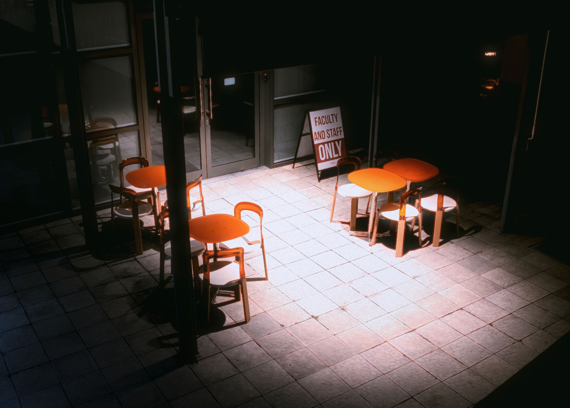 Empty taproom floor after closing with chairs stacked