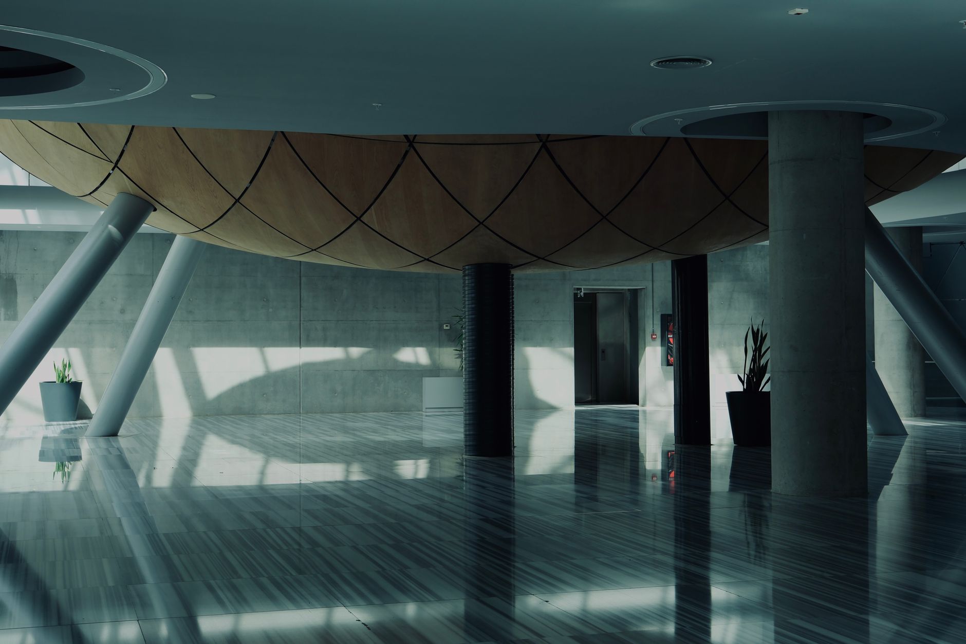 A vast, gleaming polished concrete floor in a modern facility, representing the ideal outcome of using an autonomous floor cleaner.