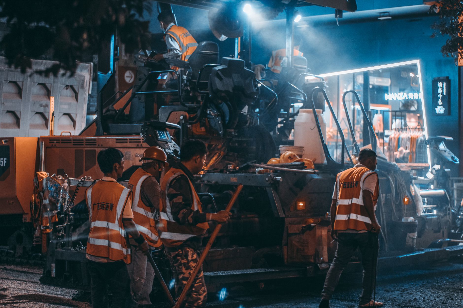 Overnight construction activity with crews, equipment, and floodlights, illustrating a site where heavy nighttime work can make autonomous patrols a poor fit.