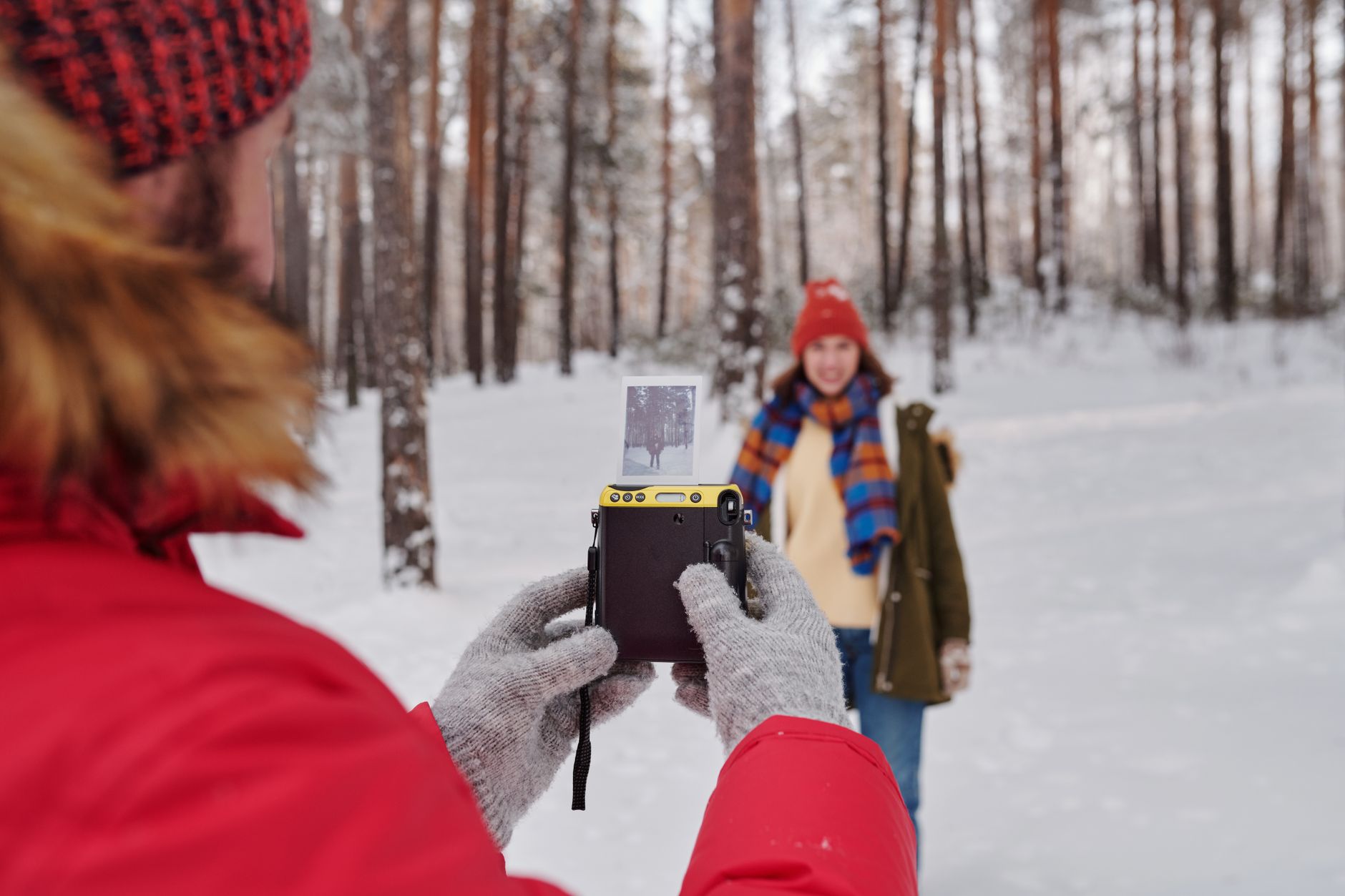 A view through a thermal camera shows the bright heat signature of a person standing out against a cool, dark background, illustrating a key advantage for after-hours security.