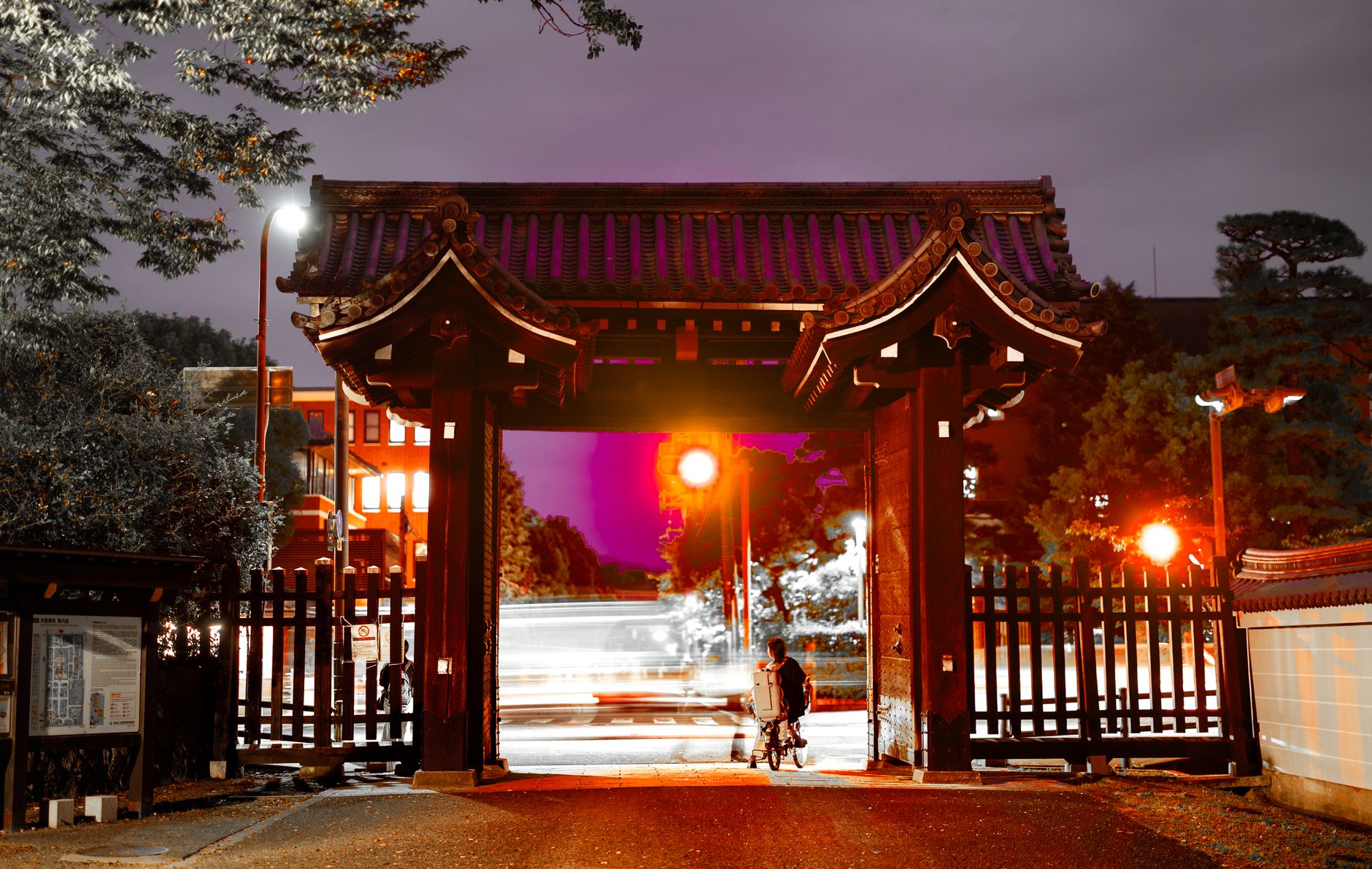A closed vehicle gate or dark parking edge at night, showing the low-traffic checkpoints operators need verified after hours.