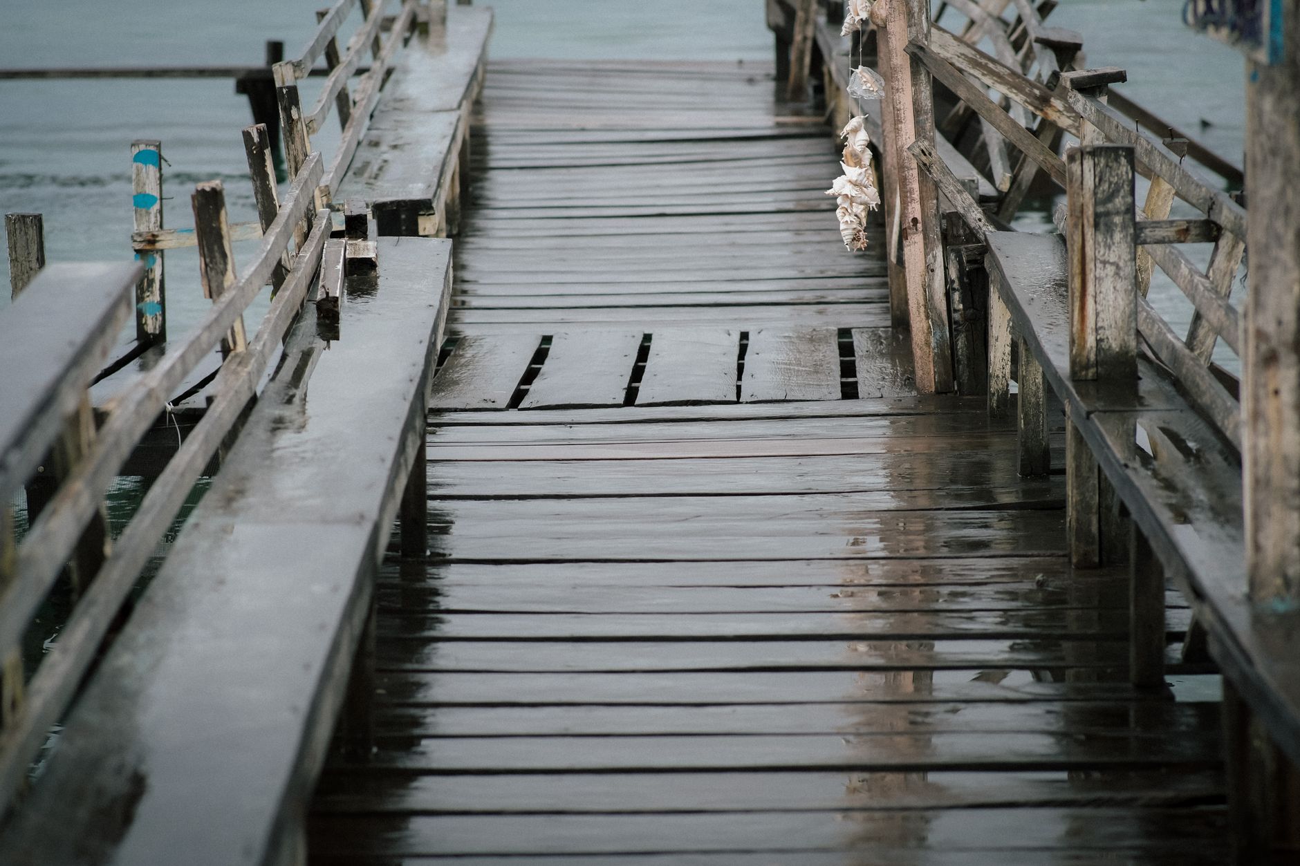 Wet pier decking and salt-spray conditions that affect traction and corrosion planning for mobile patrol routes.