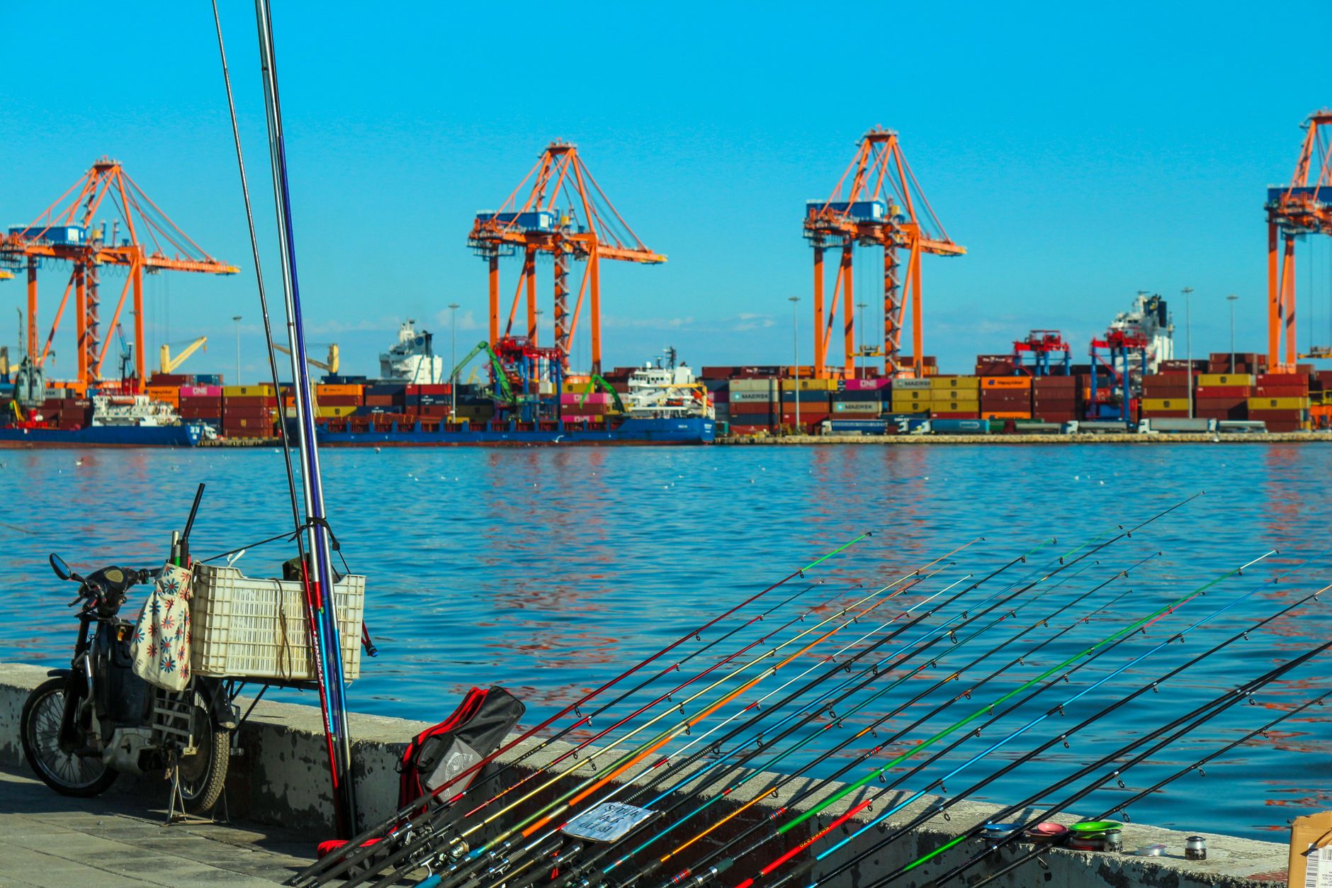 Commercial fishing vessels tied along a working harbor pier at dawn, illustrating the mixed public and restricted zones patrol programs must cover.
