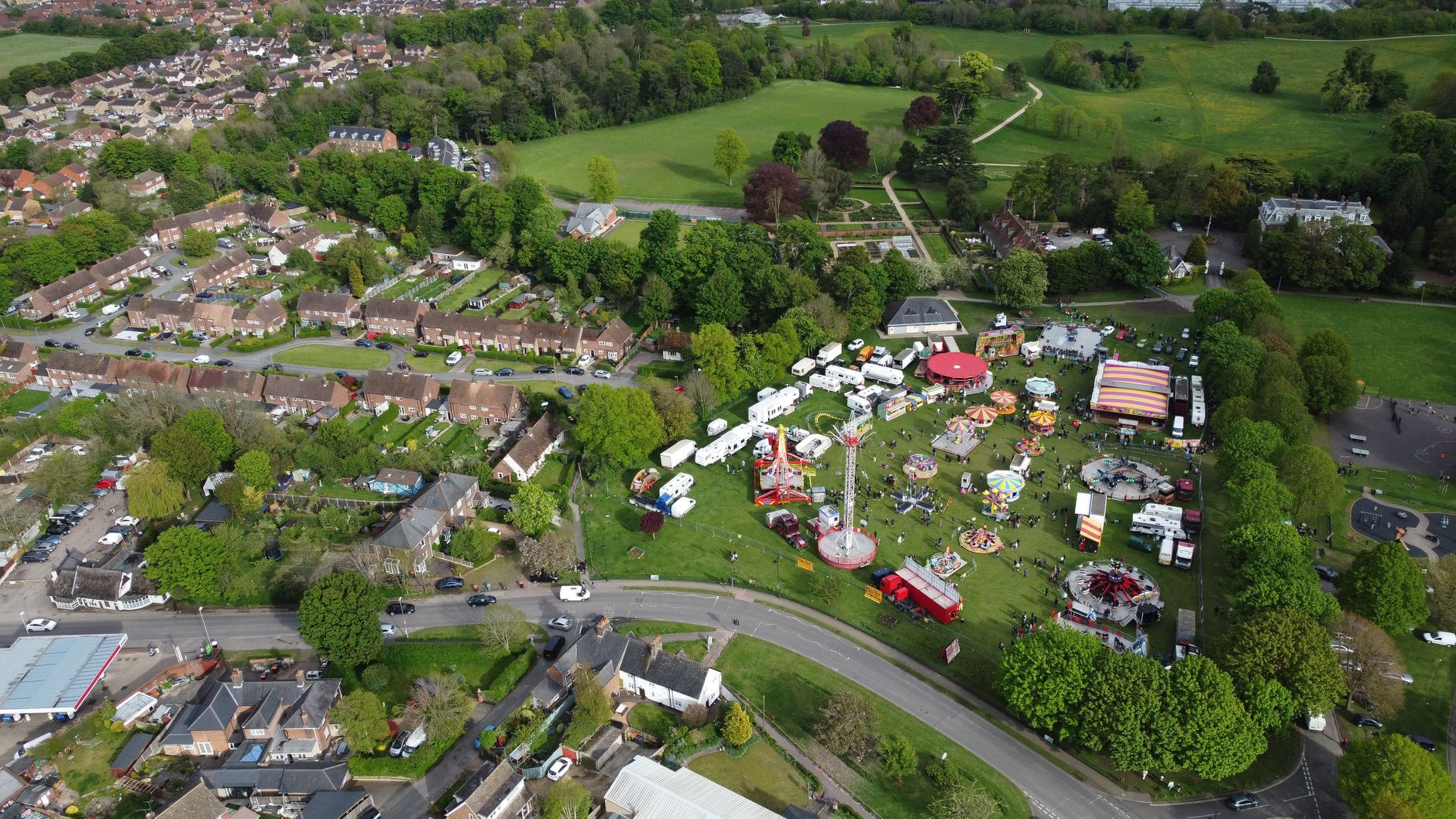 An empty service road winds between fairground buildings and outdoor areas.