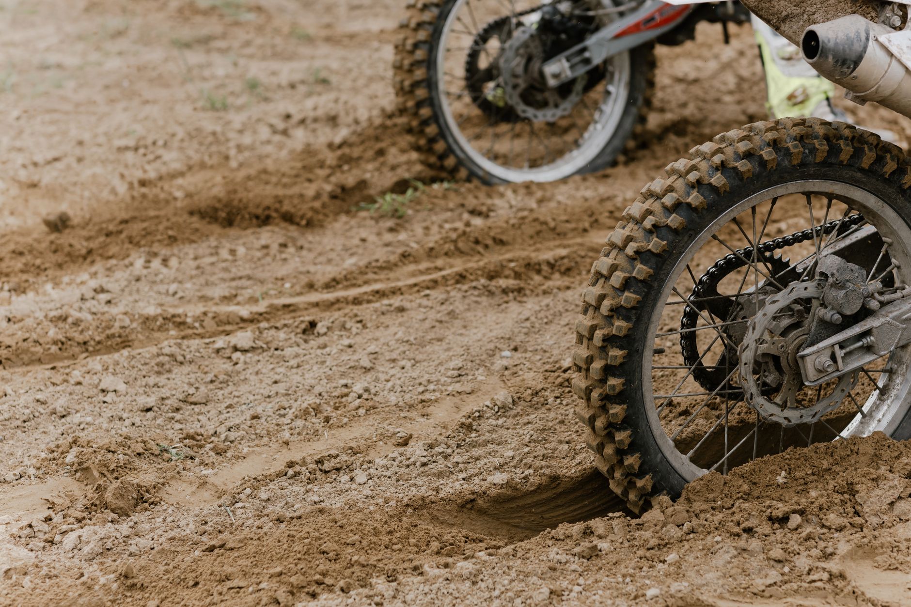 Deep tire tracks and loose gravel illustrating the uneven surfaces found around equipment lots.