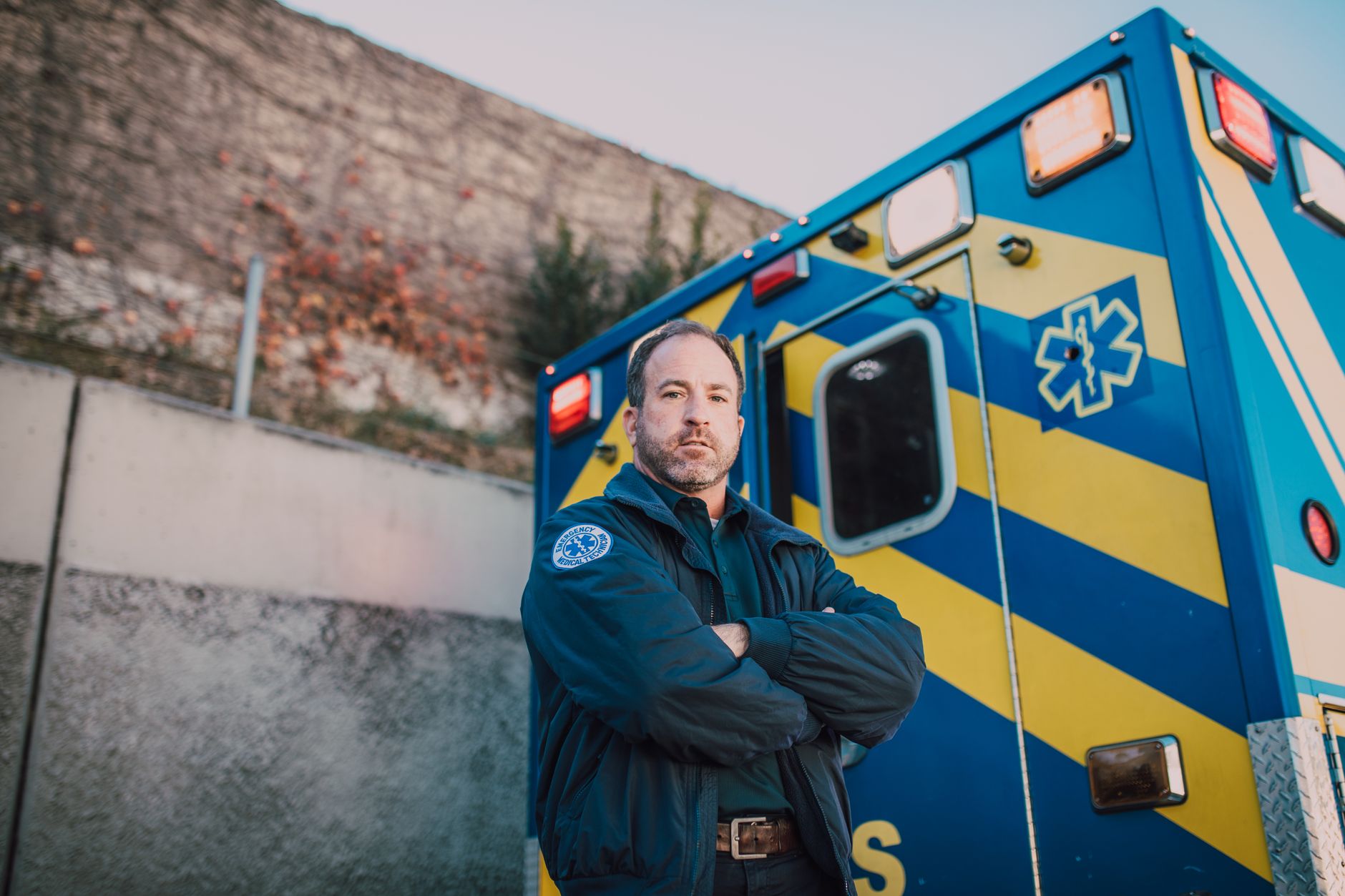 An ambulance-adjacent hospital service area with vehicle circulation space, showing why side-door monitoring must not interfere with emergency access.